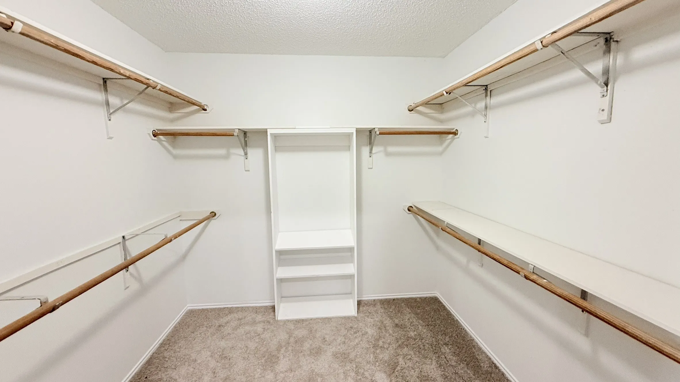 Walk in closet with light carpet