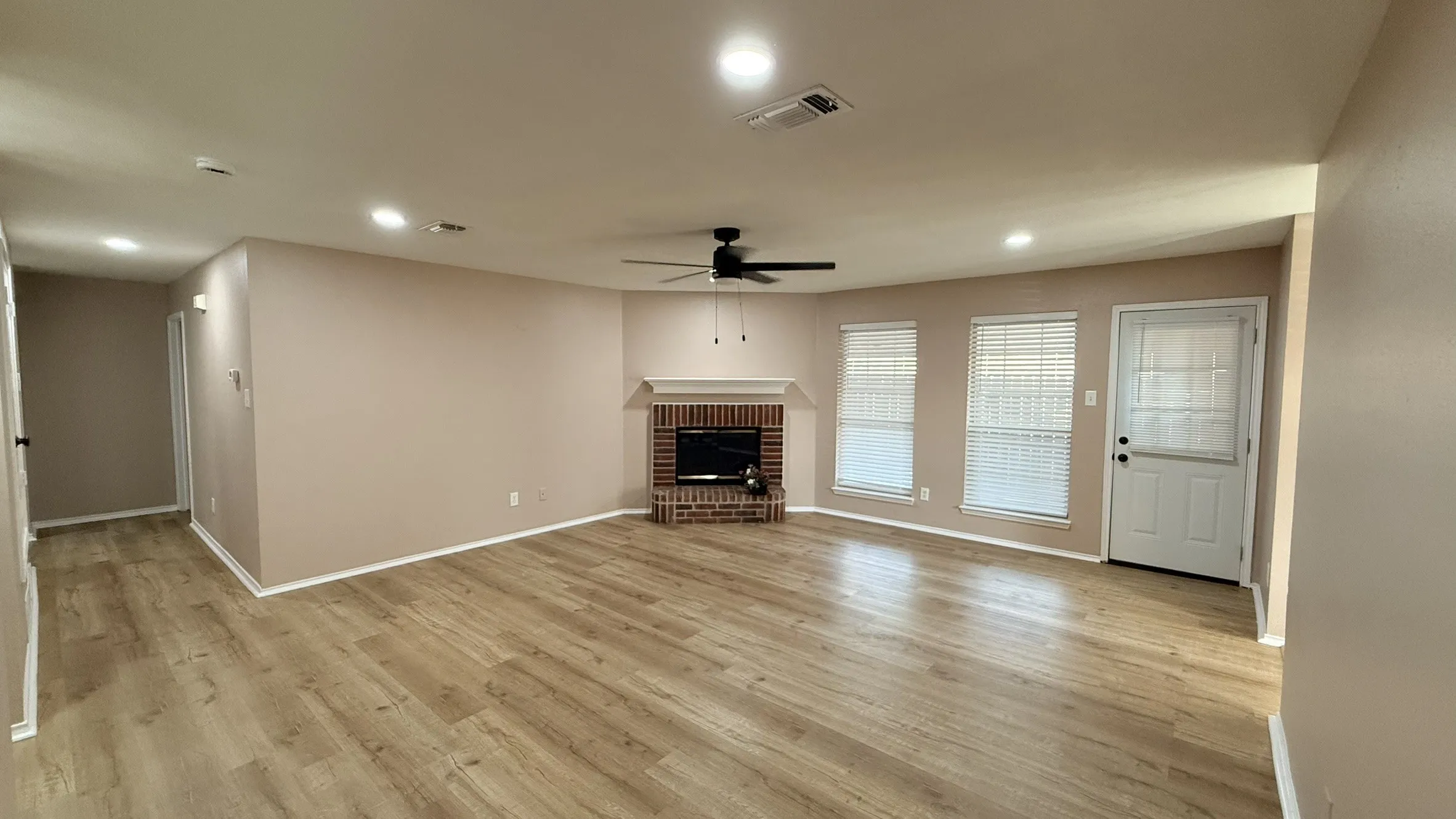 Unfurnished living room featuring a fireplace, ceiling fan, recessed lighting, and light wood-type flooring