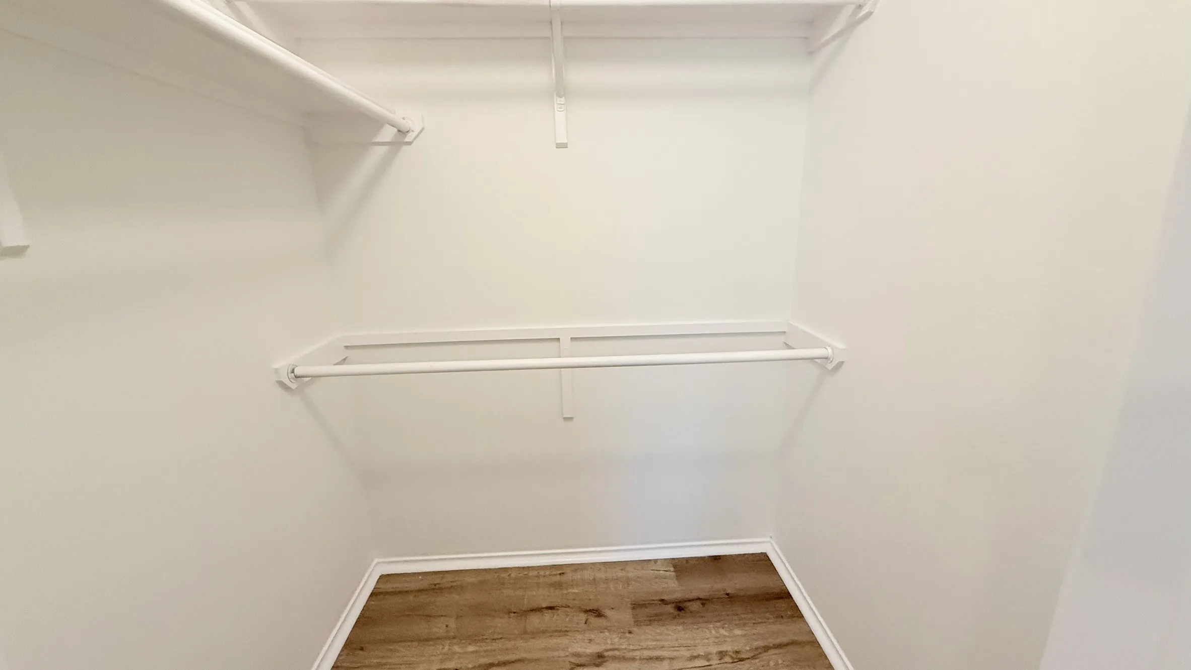 Walk in closet featuring light wood-style floors