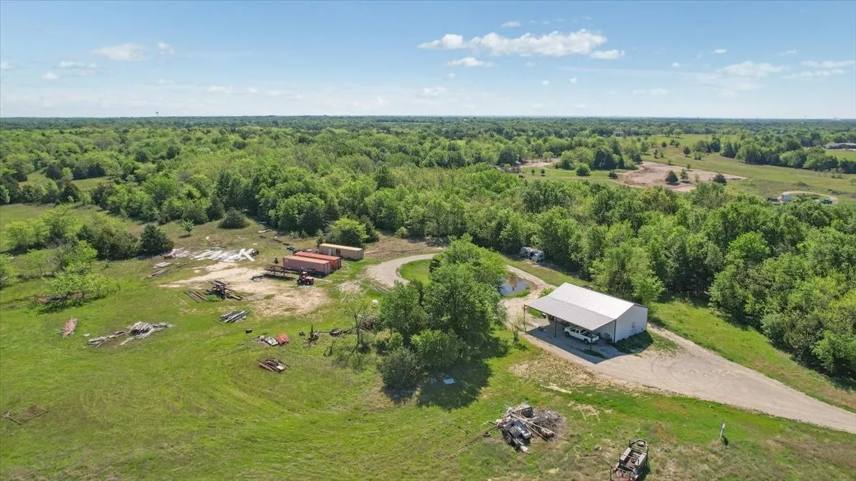 Aerial view of sparsely populated area with a heavily wooded area