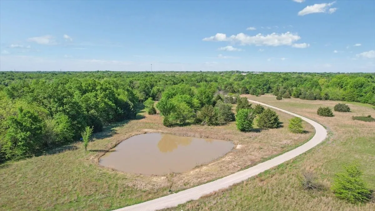 Bird's eye view of a nearby body of water and a heavily wooded area