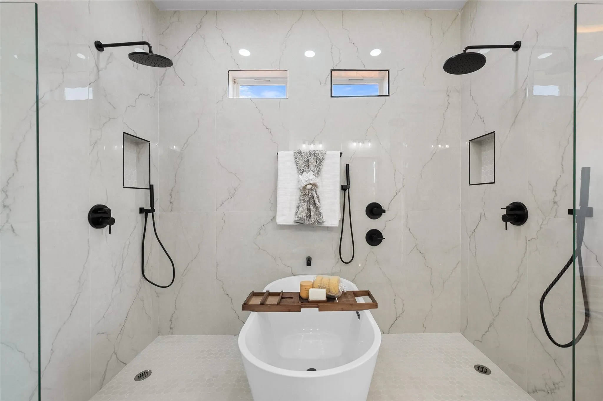 Spa like bathroom with dual rain shower heads and wall sprayers