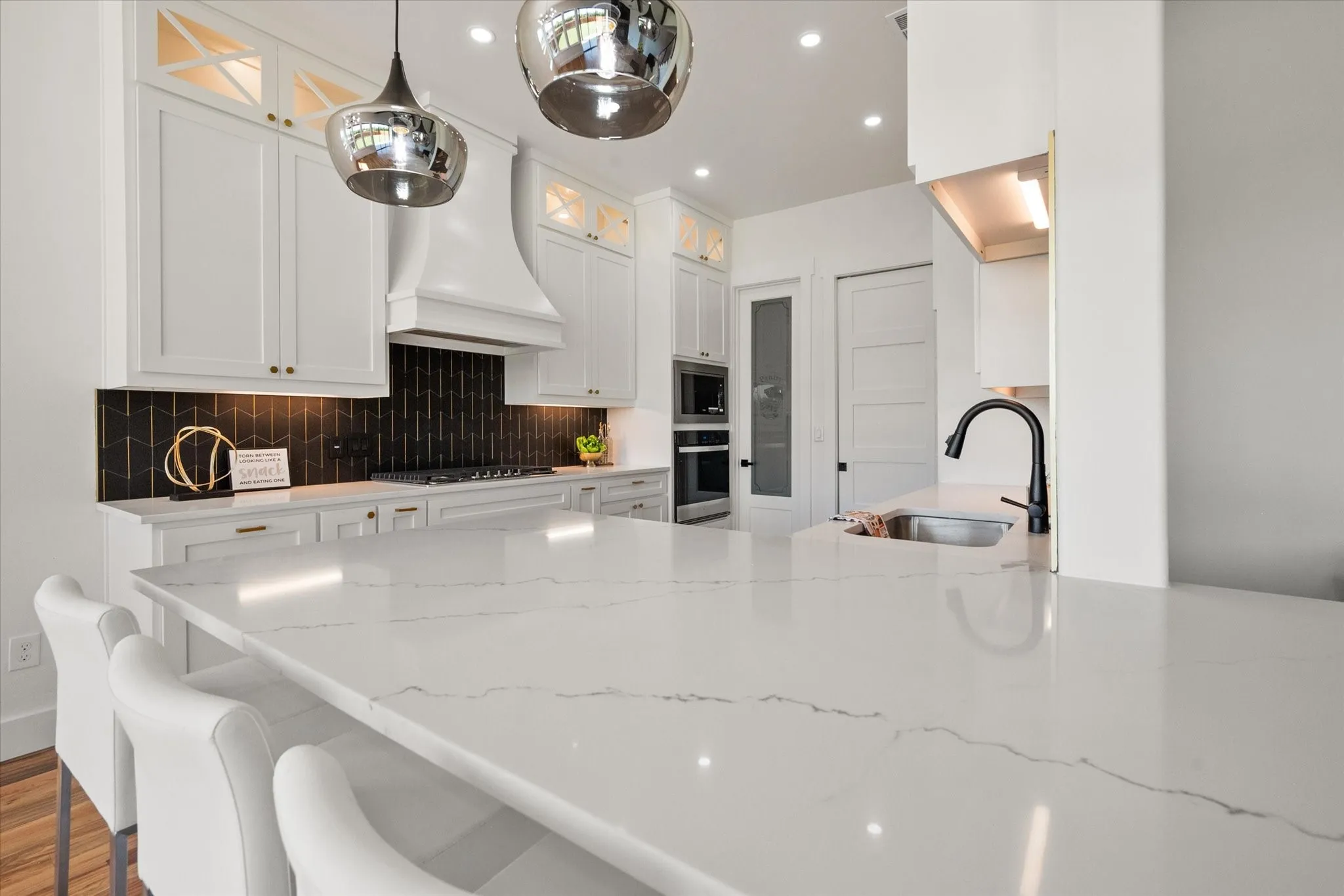 Gorgeous Quartz counters with modern pendant lighting