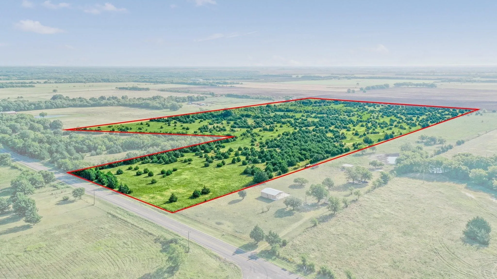 Overview of rural landscape with property boundaries highlighted and large plots for crops