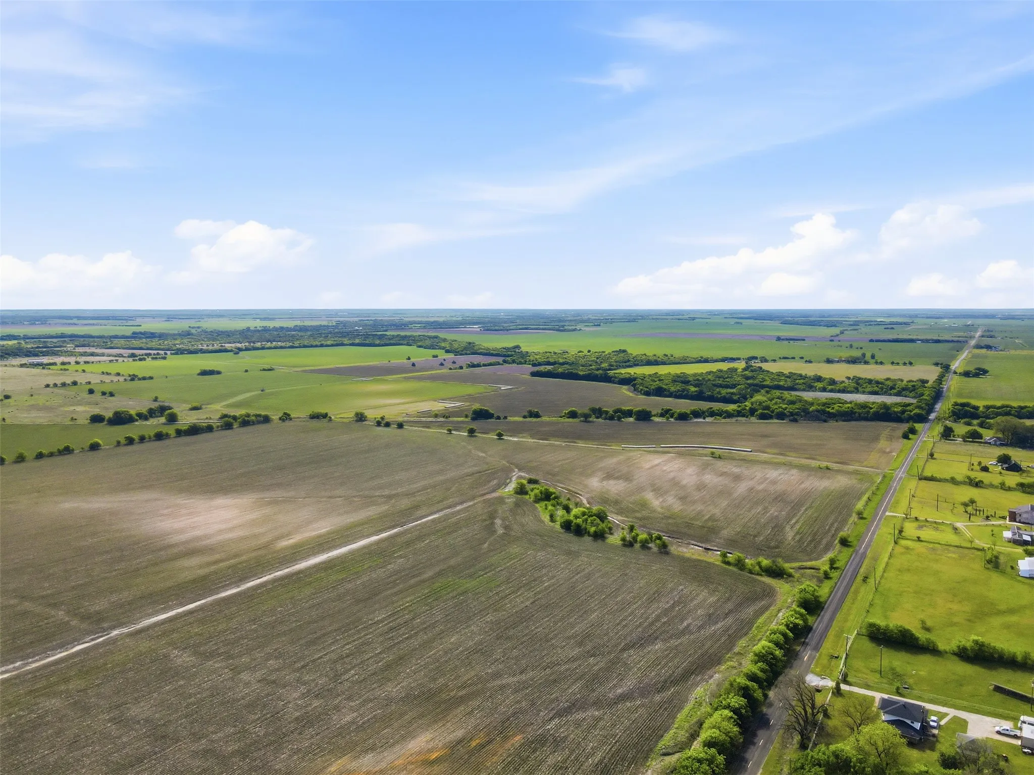 View of rural area featuring rows of crops