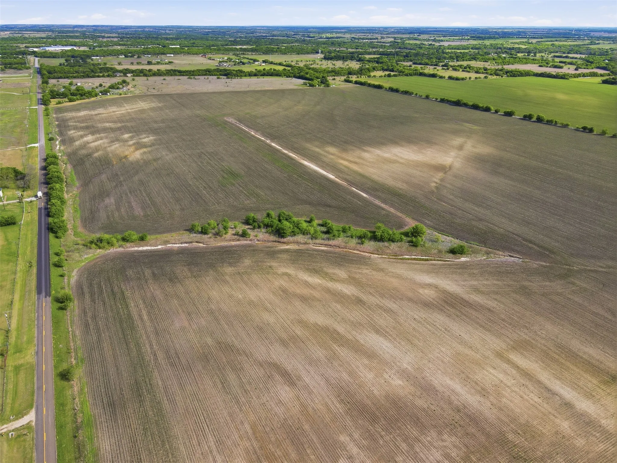 Overview of rural landscape with rows of crops