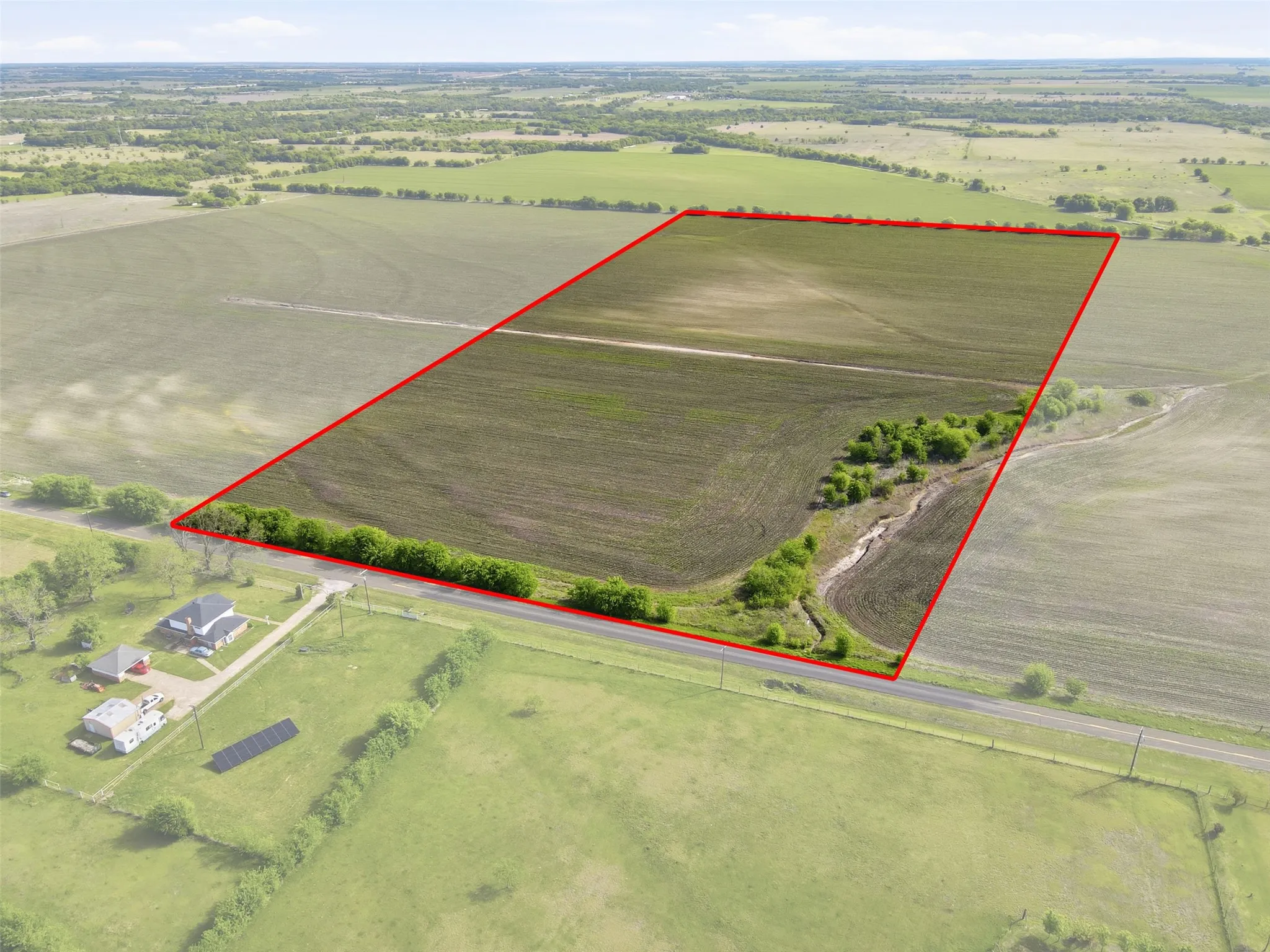 Aerial view of sparsely populated area with property boundaries highlighted