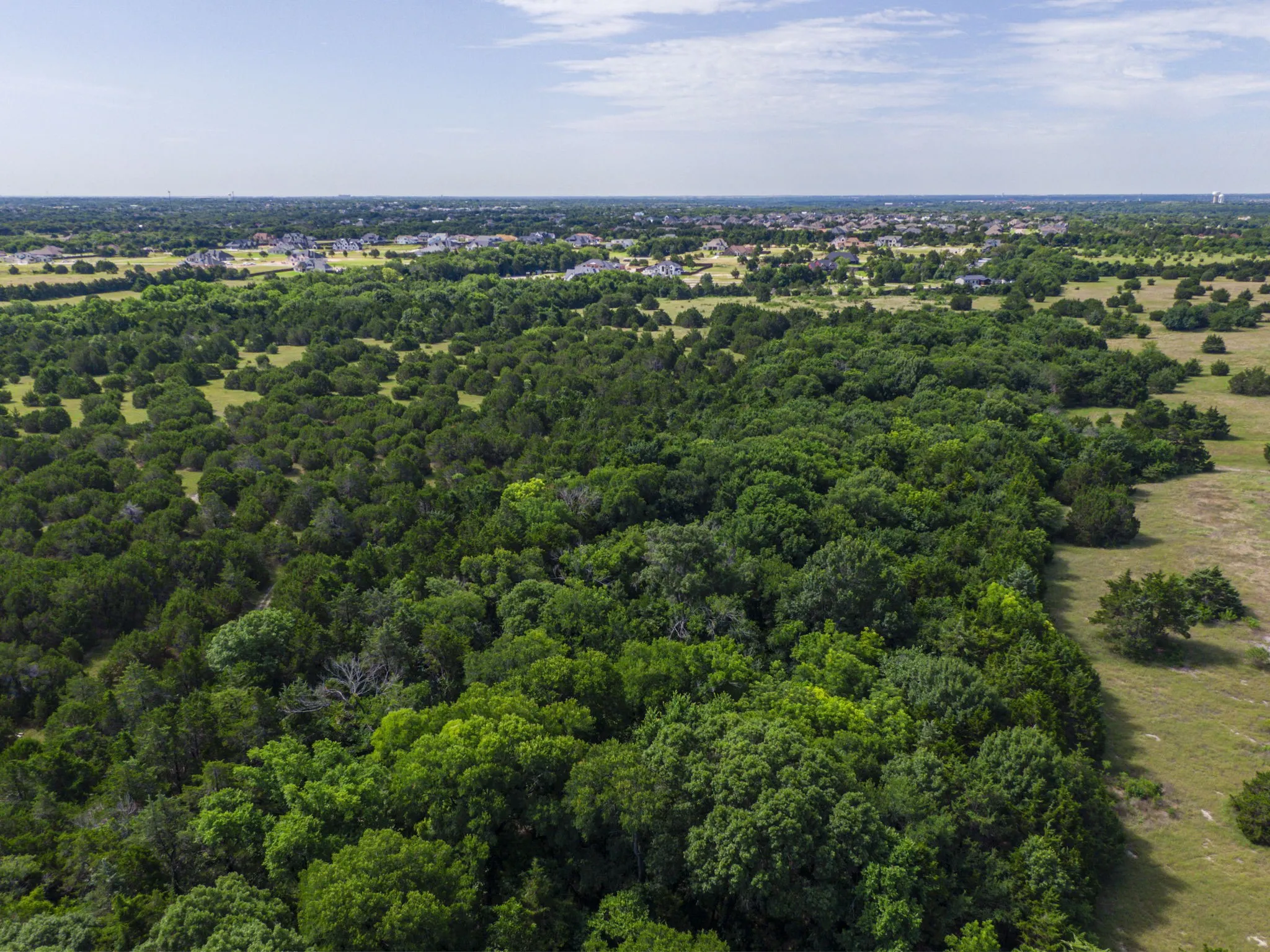 Drone / aerial view of a heavily wooded area