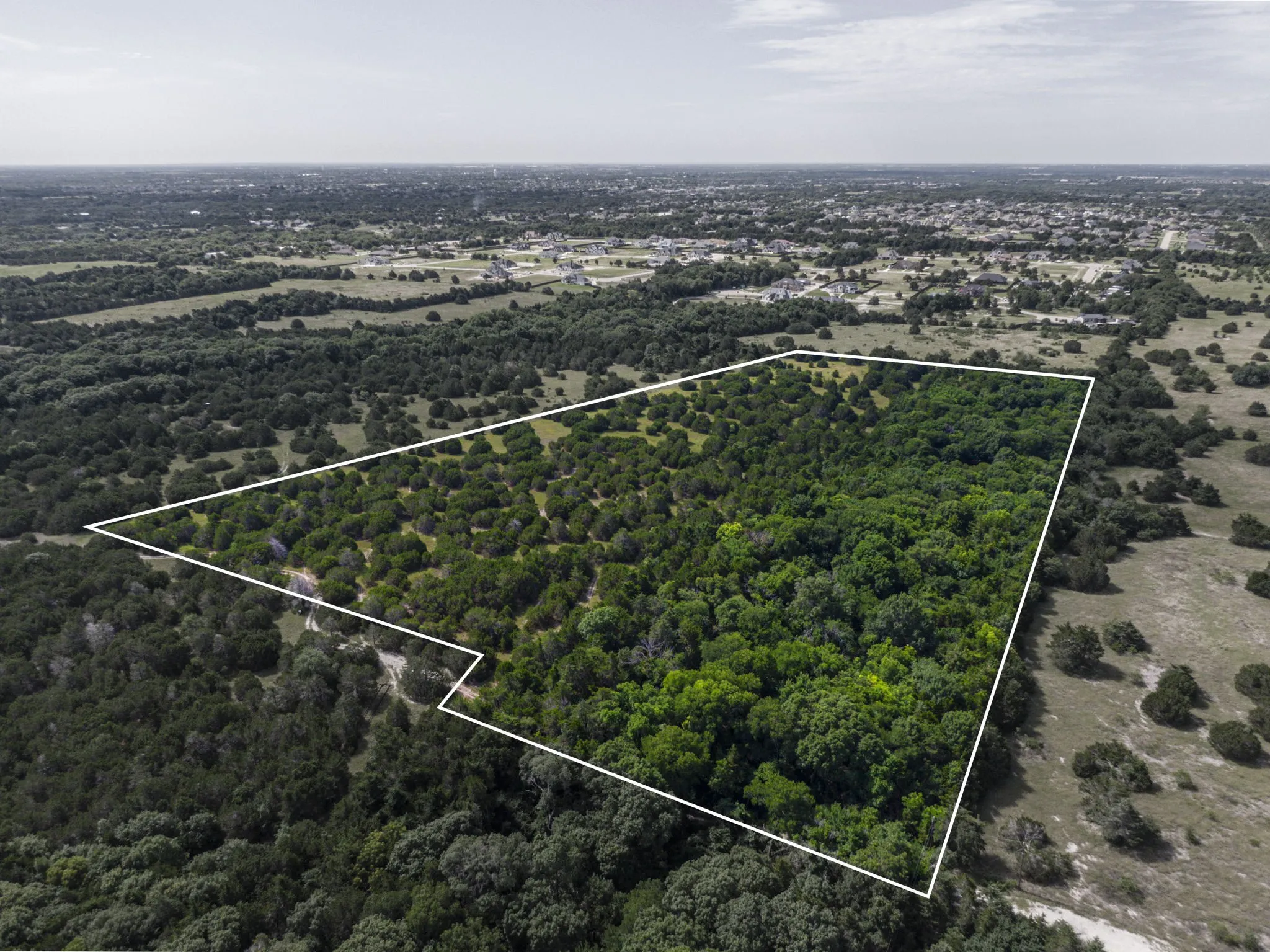 Aerial view of property and surrounding area with property boundaries highlighted