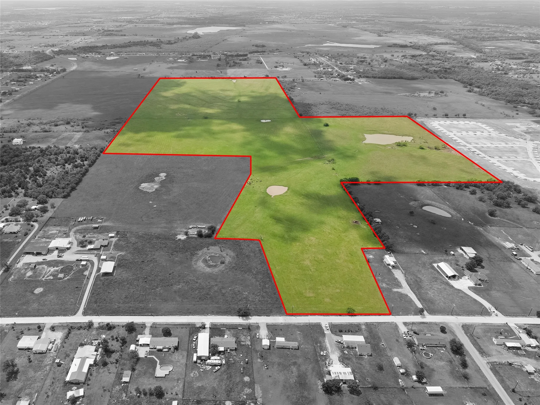 Aerial view of property and surrounding area featuring property parcel outlined