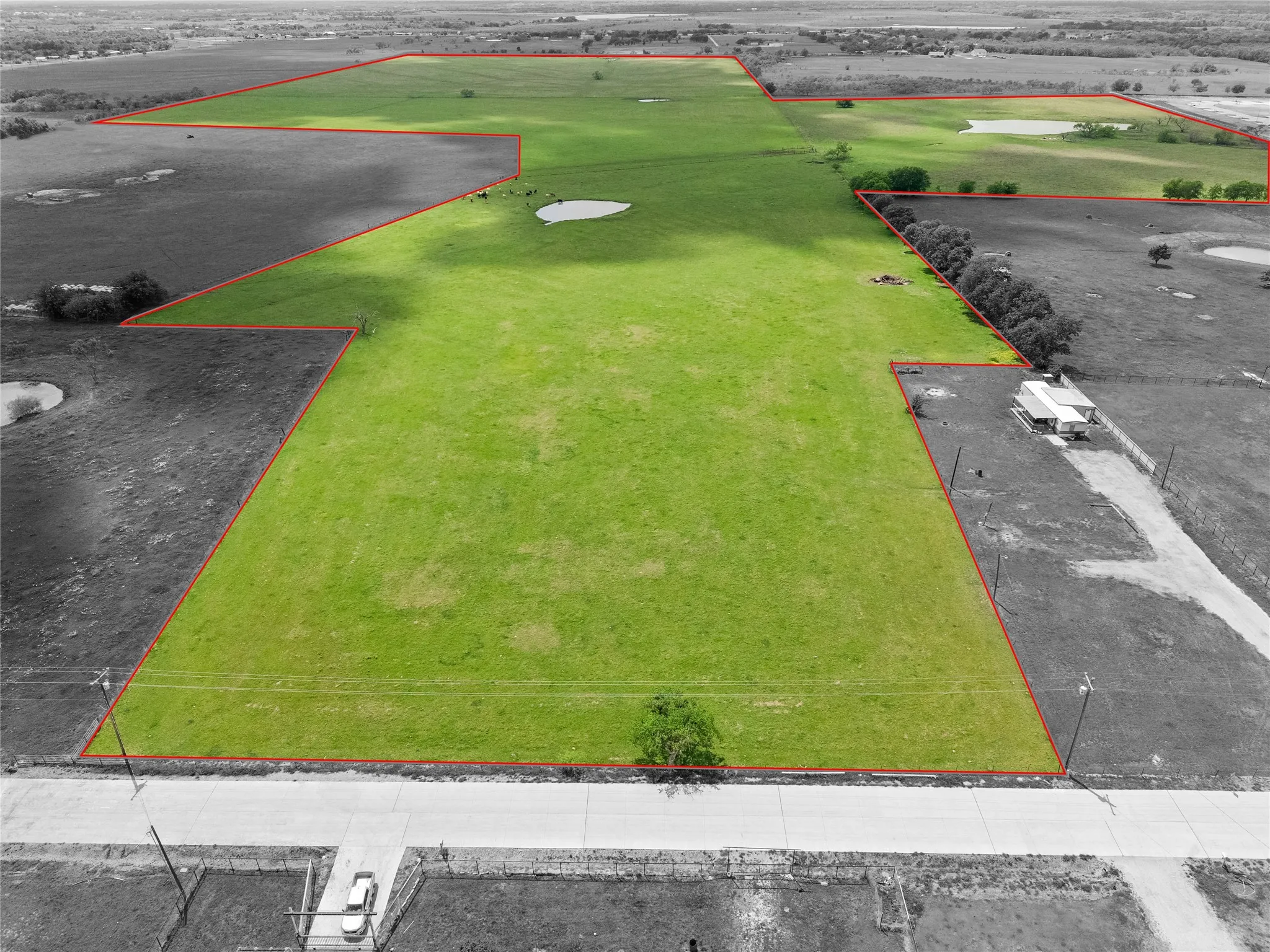 Aerial view of property and surrounding area featuring property parcel outlined