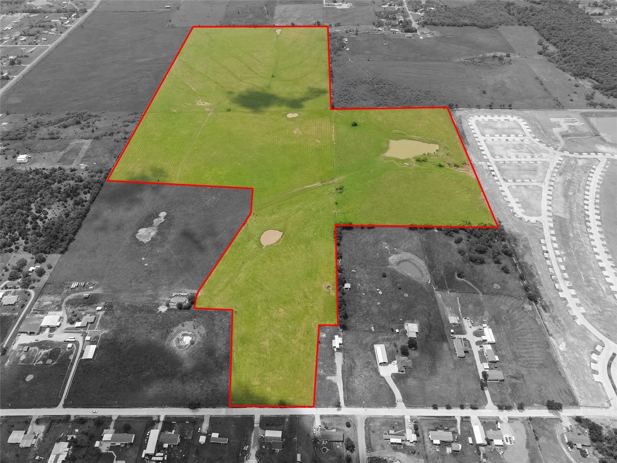 Aerial view of property and surrounding area featuring property parcel outlined