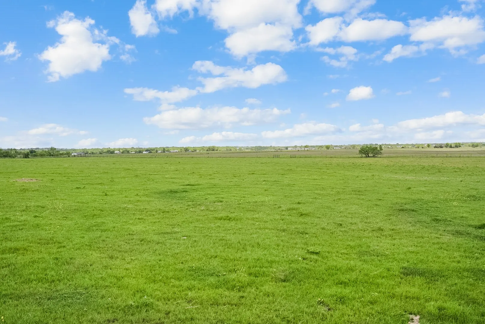View of green lawn with a view of countryside