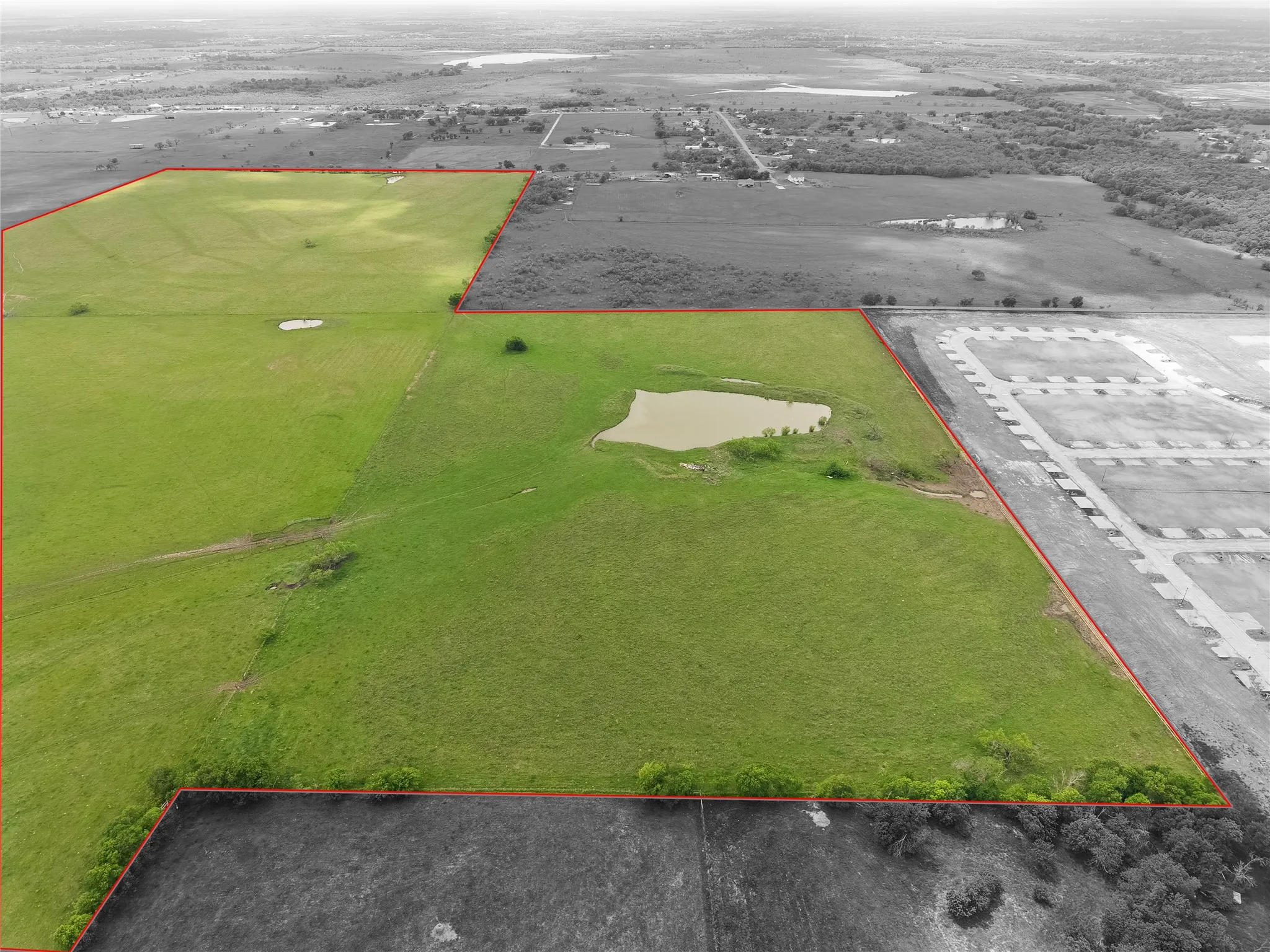 Aerial view of sparsely populated area featuring property boundaries highlighted