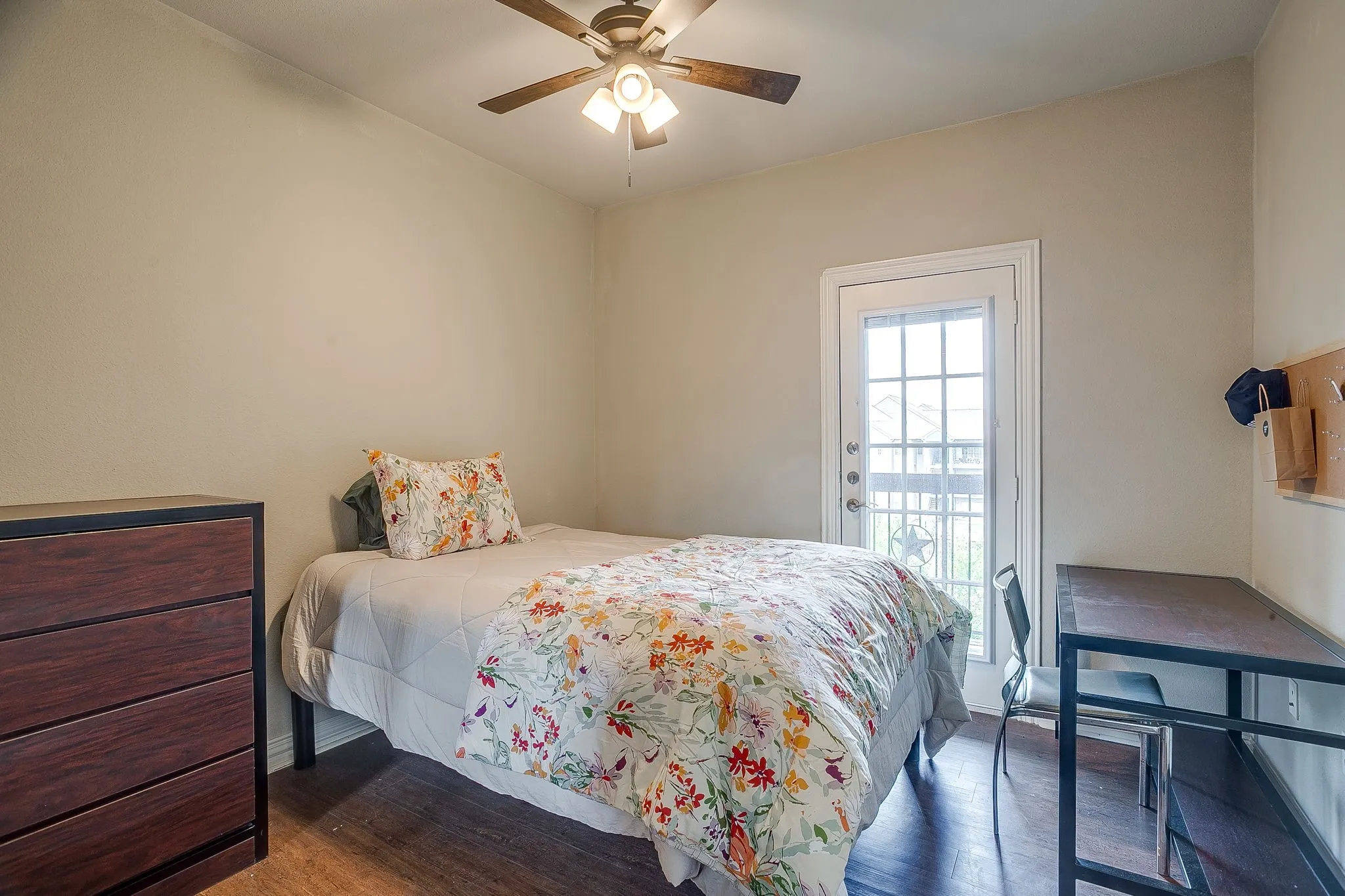 Bedroom with dark wood-style floors and ceiling fan