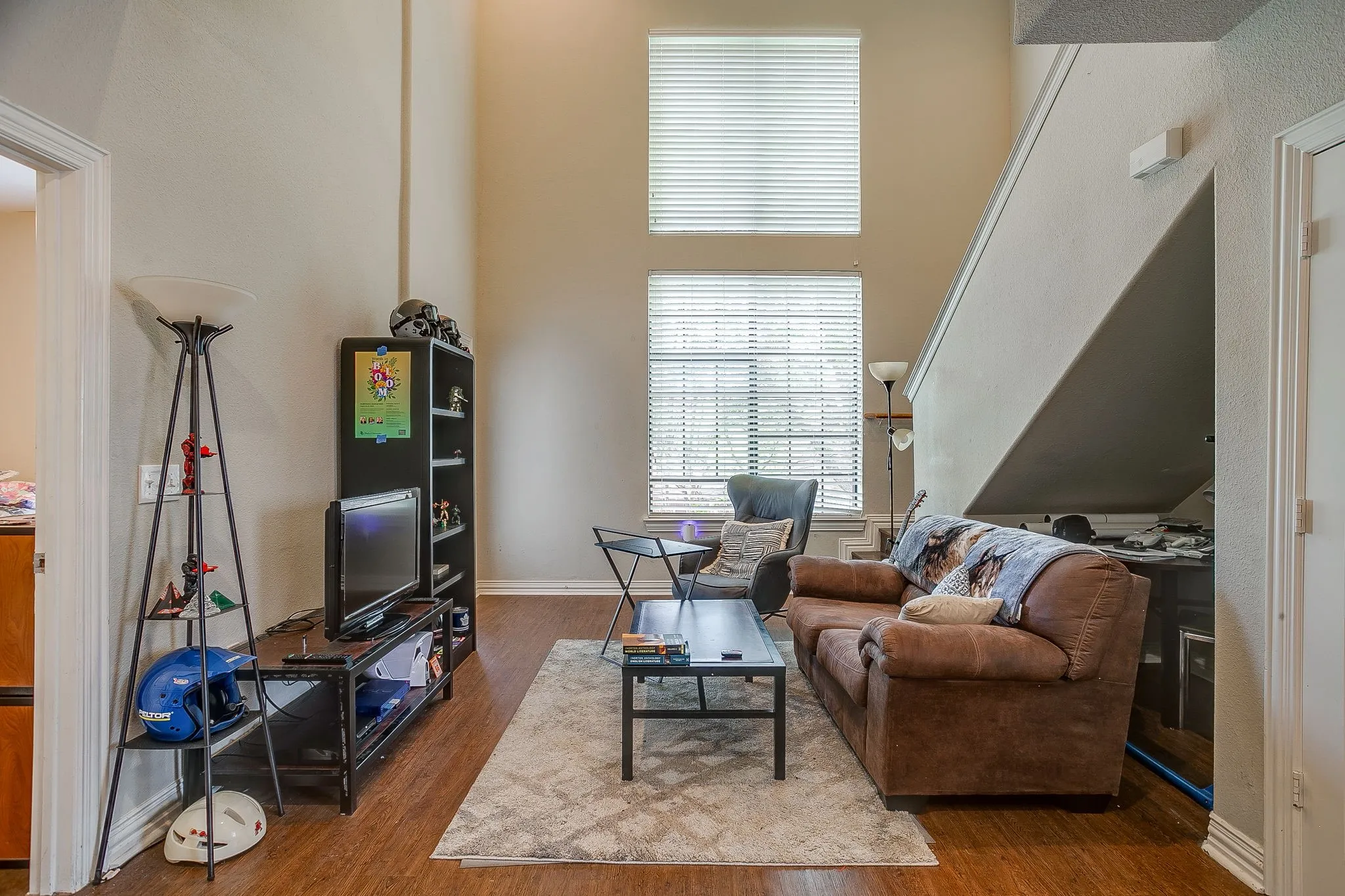 Living area featuring a high ceiling and wood finished floors