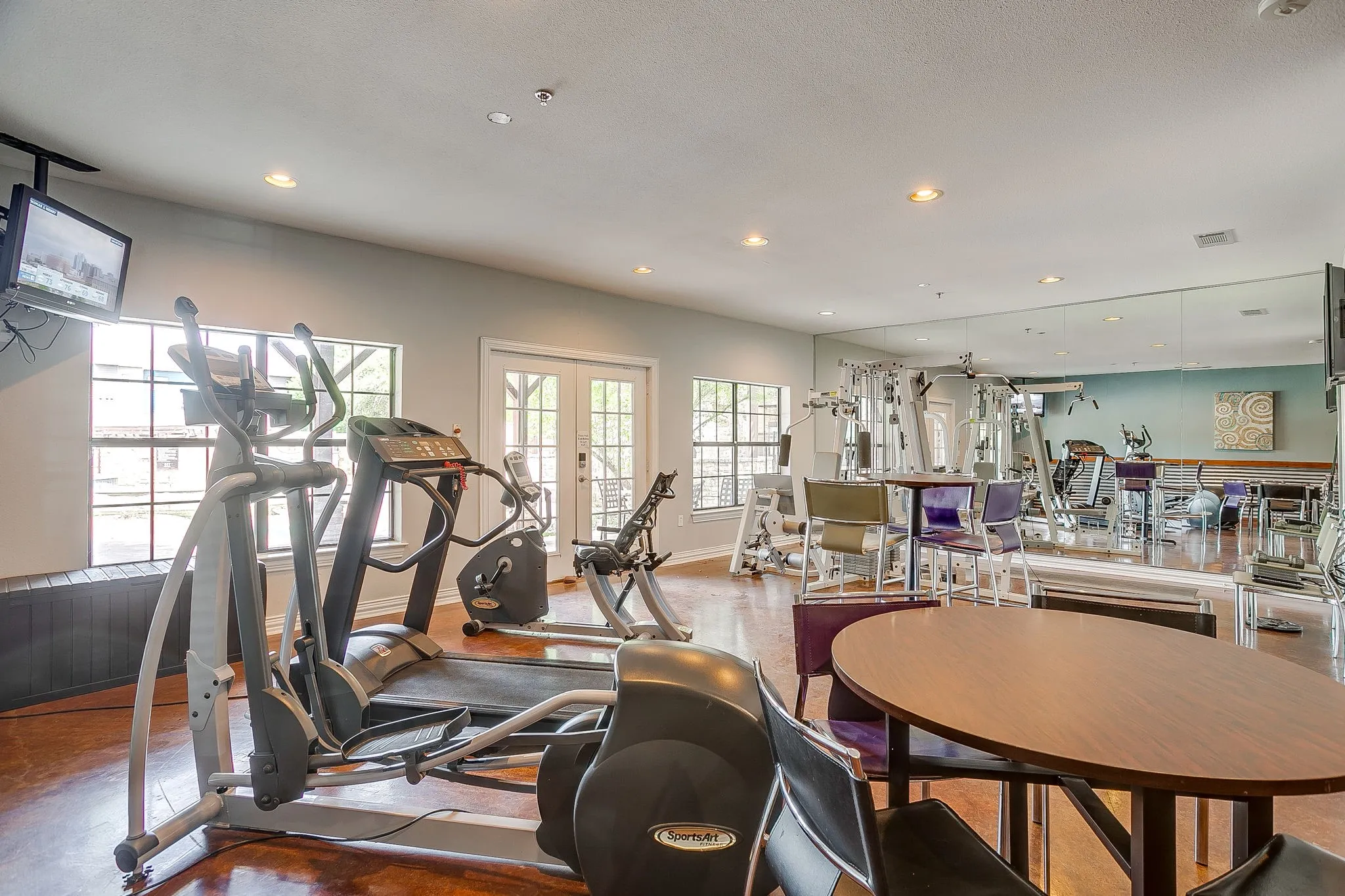 Workout area with french doors and recessed lighting