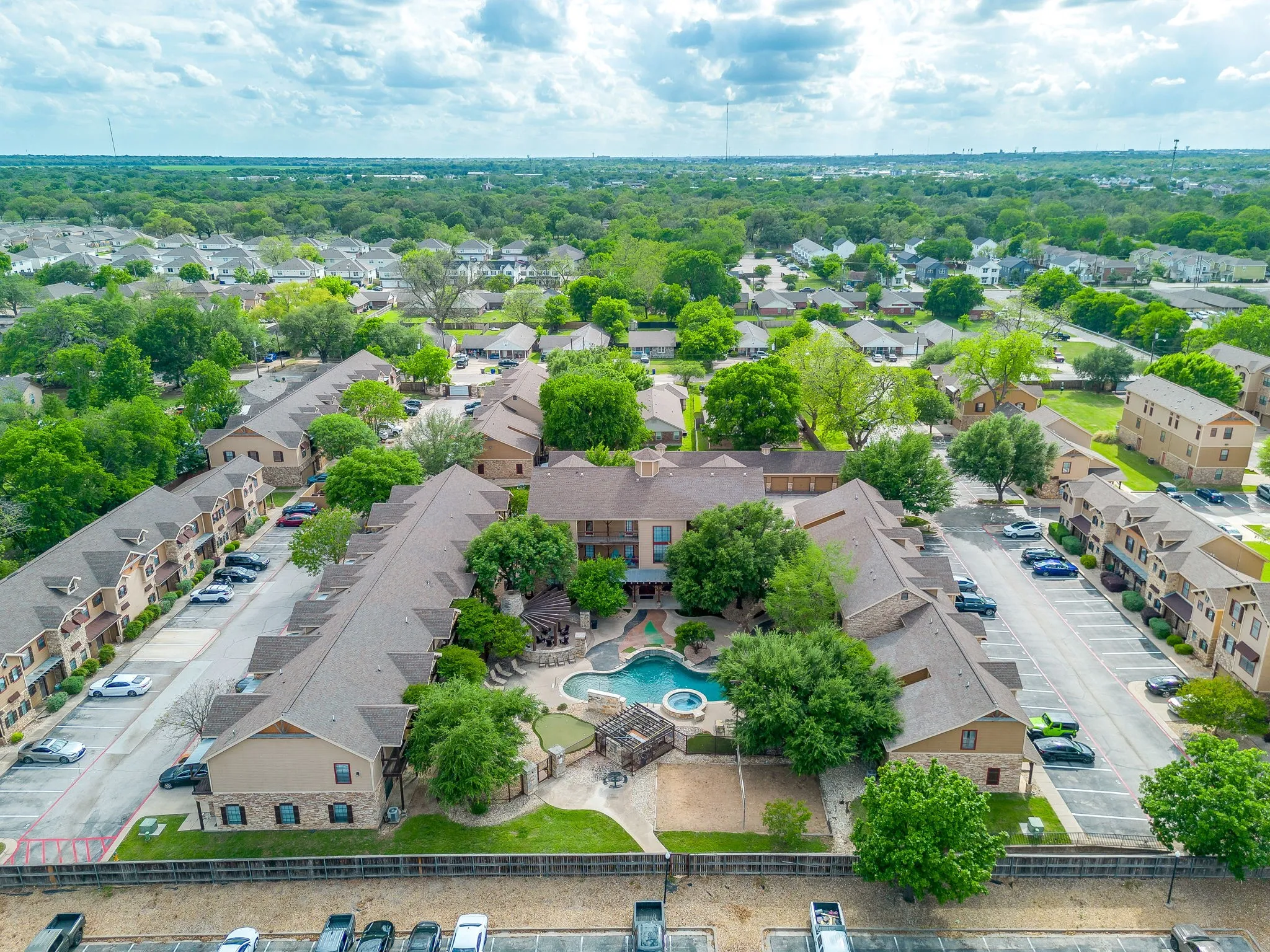 Aerial perspective of suburban area featuring a pool