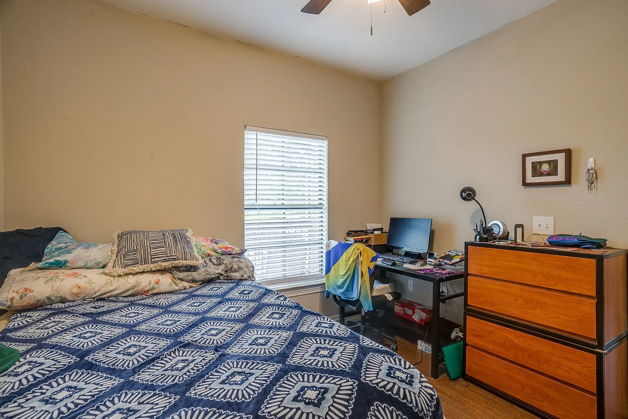 Bedroom featuring ceiling fan and wood finished floors
