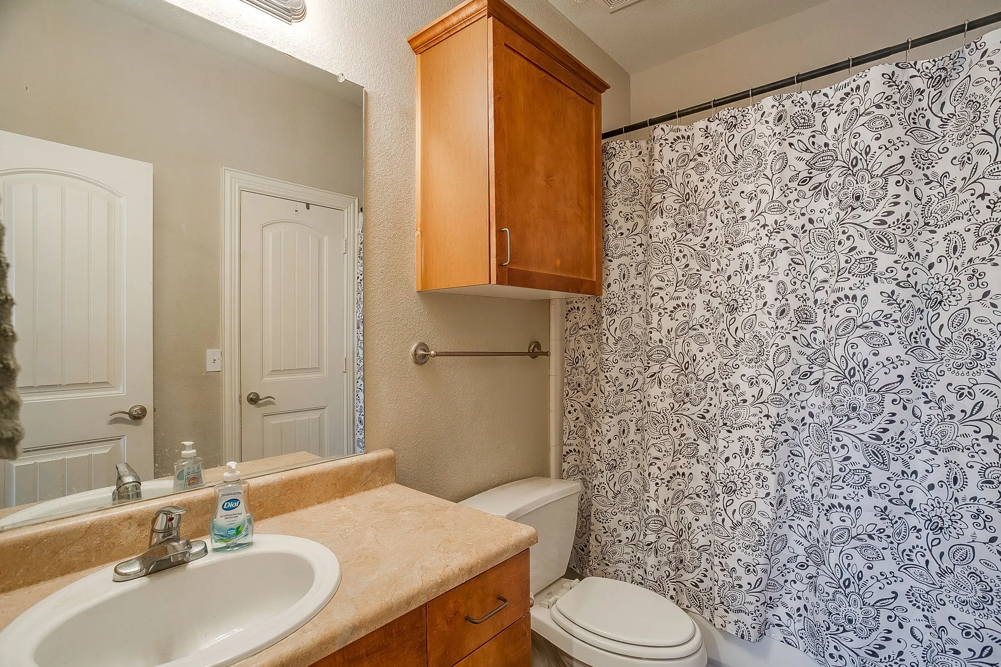 Bathroom featuring vanity and a textured wall