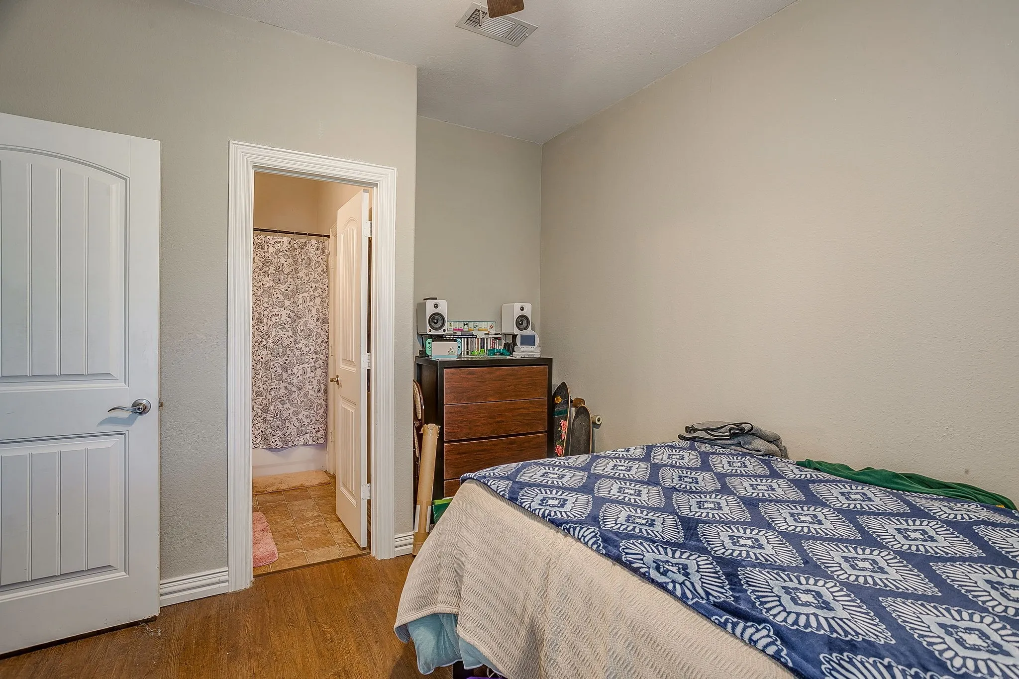 Bedroom featuring wood finished floors and ensuite bathroom