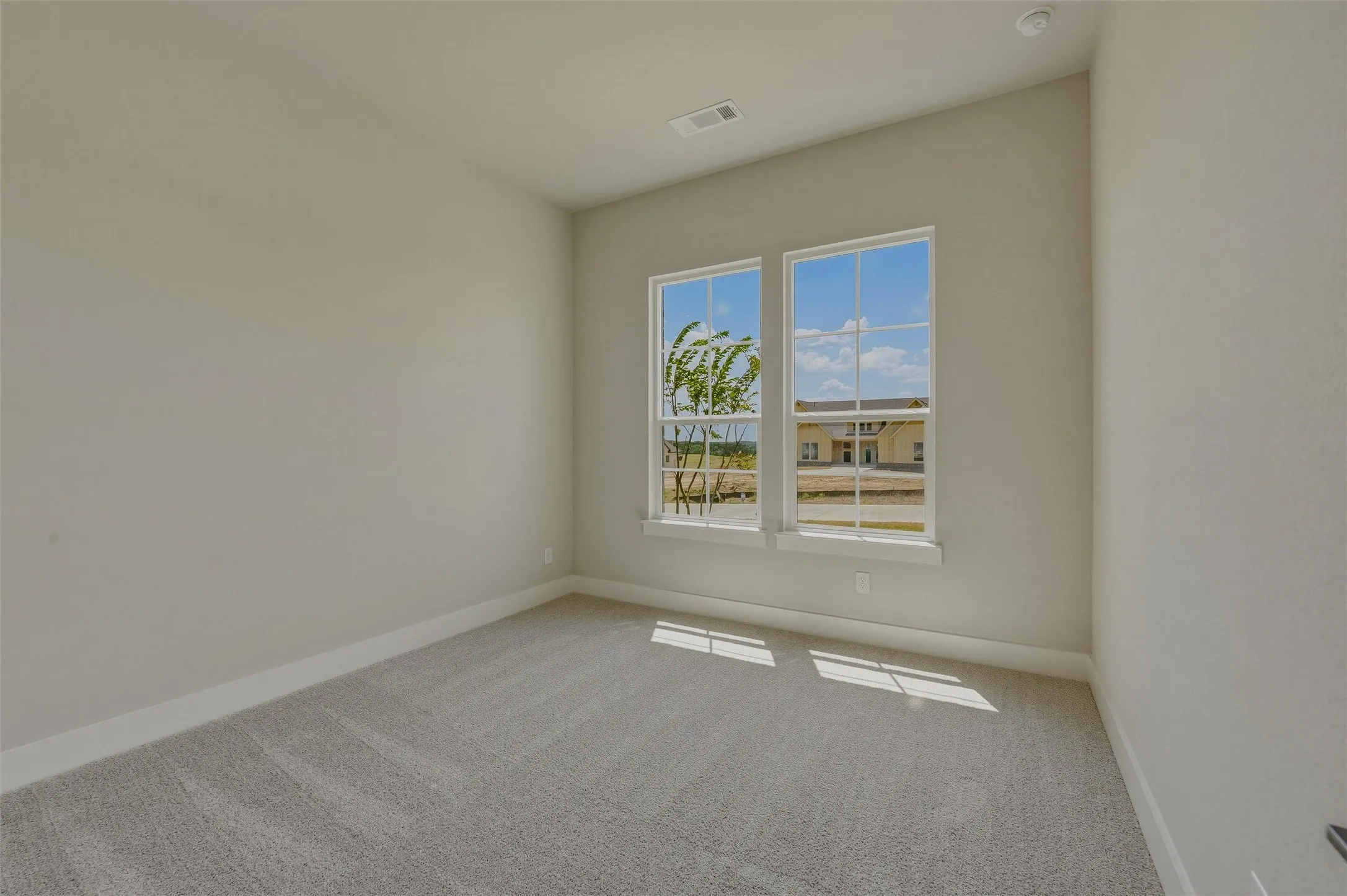 Neutral wall paint, plush carpet flooring, and white trim throughout