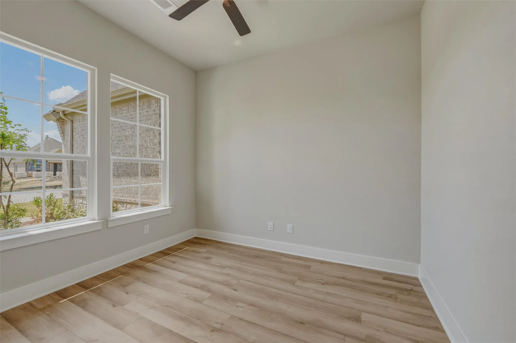 Room featuring wood-finish flooring and light gray walls