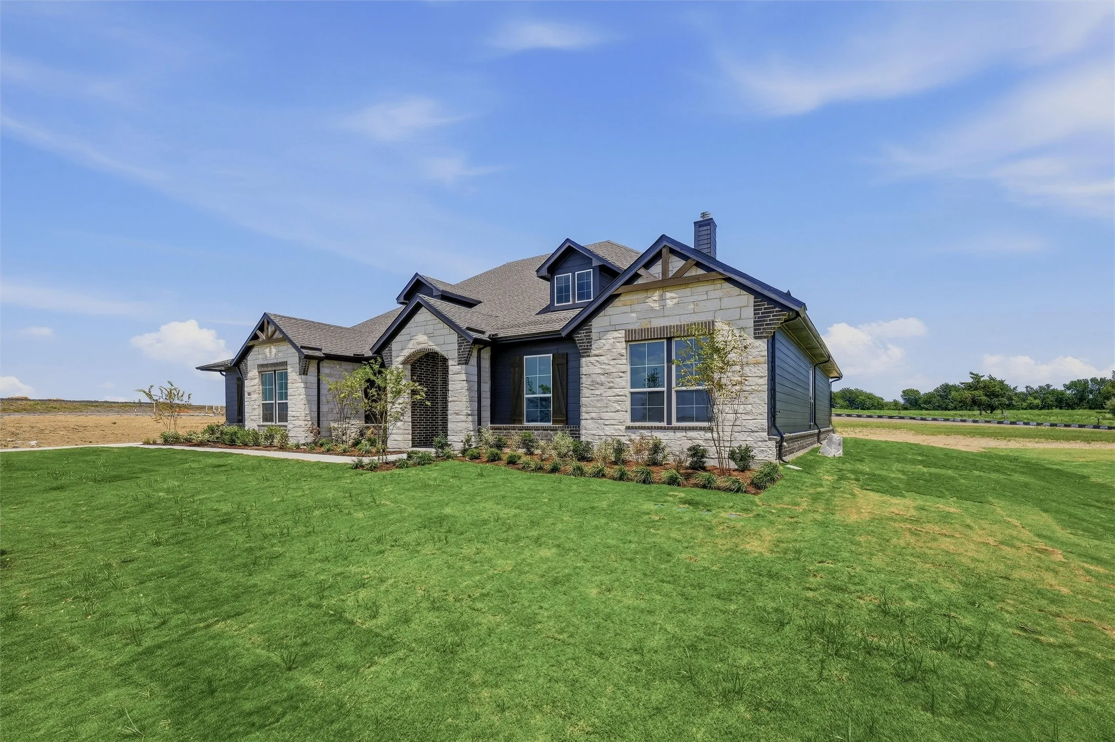 Stone and siding exterior with dark trim accents