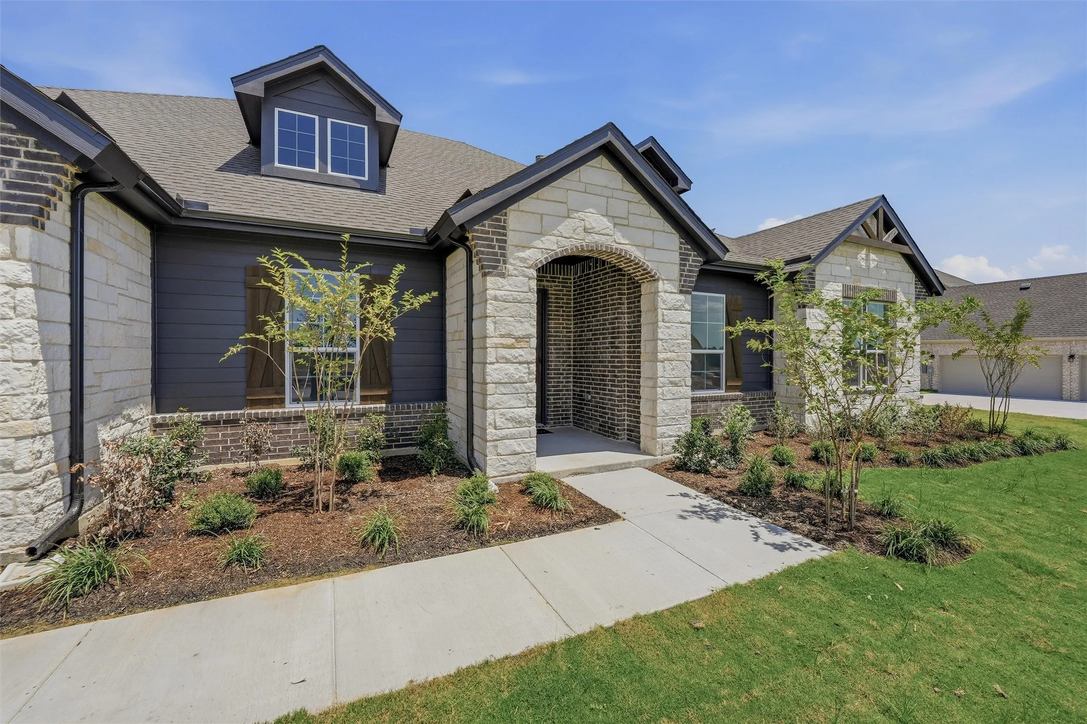 Stone and brick exterior with dark siding accents