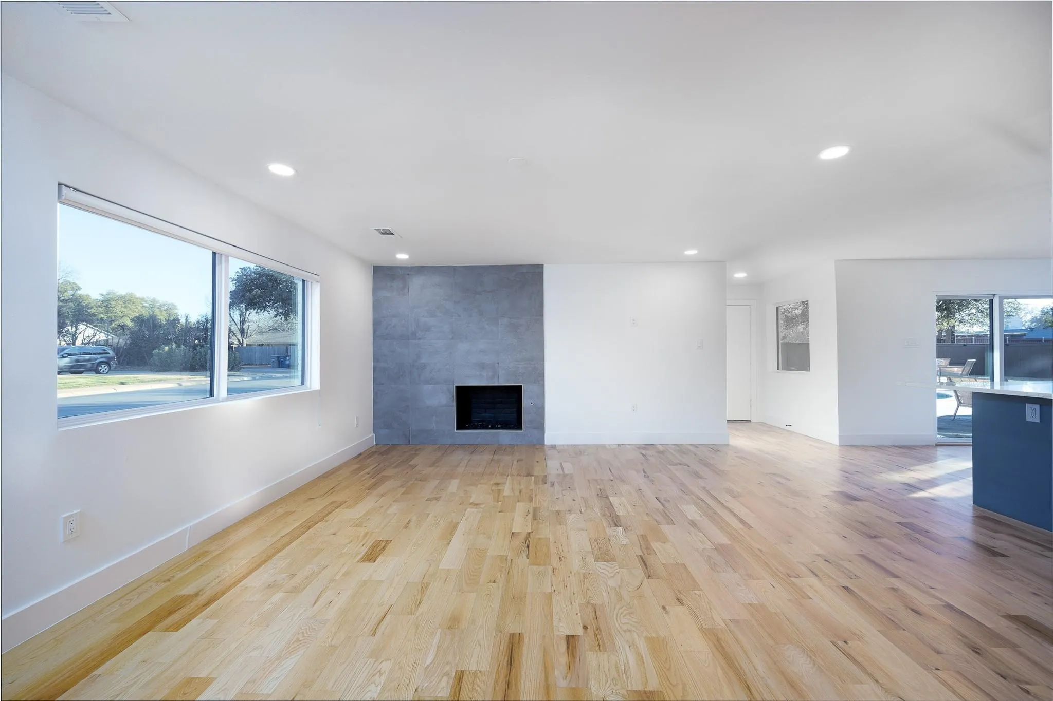 Family room with fireplace and gleaming new floors