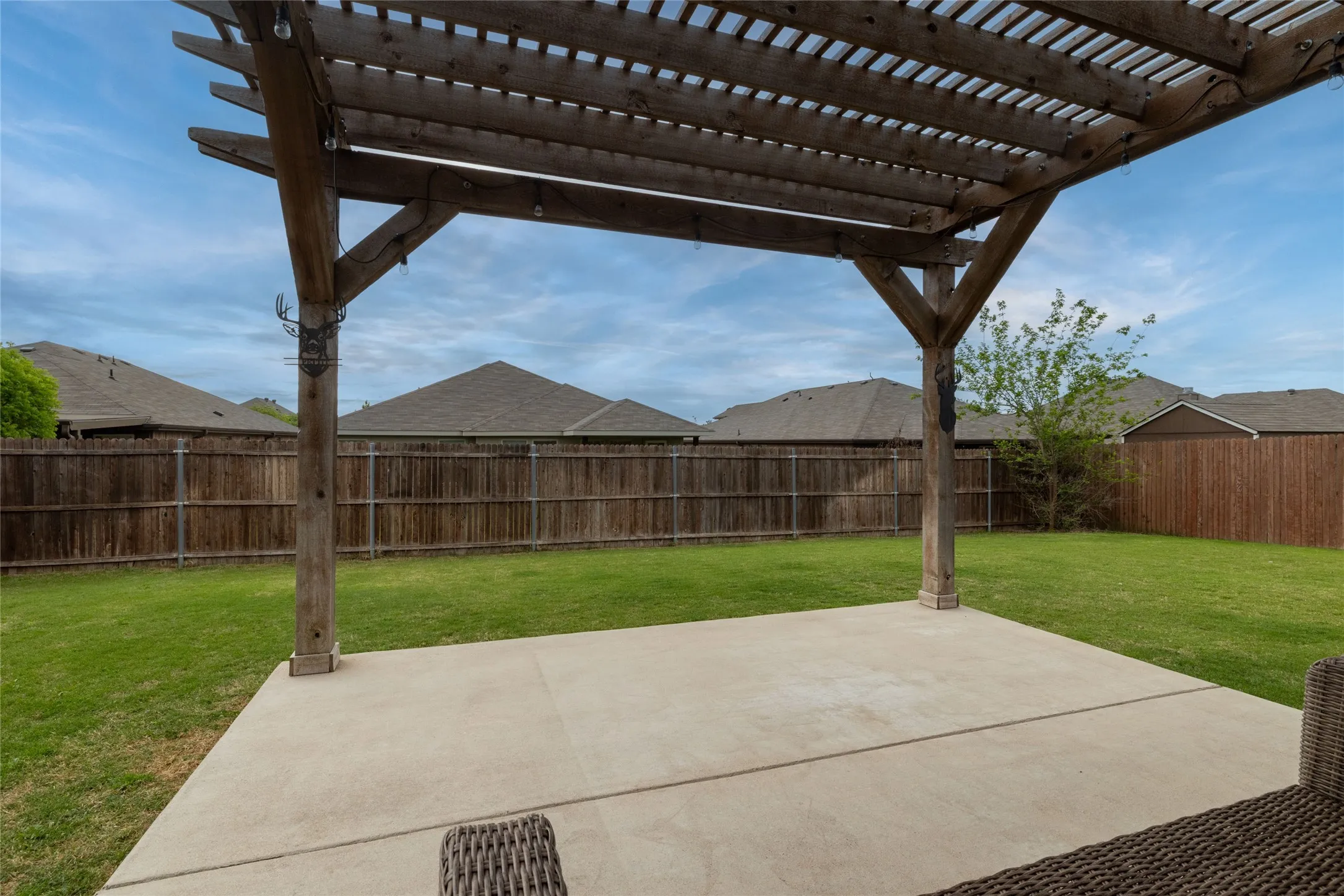 Fenced backyard featuring a pergola and a patio area