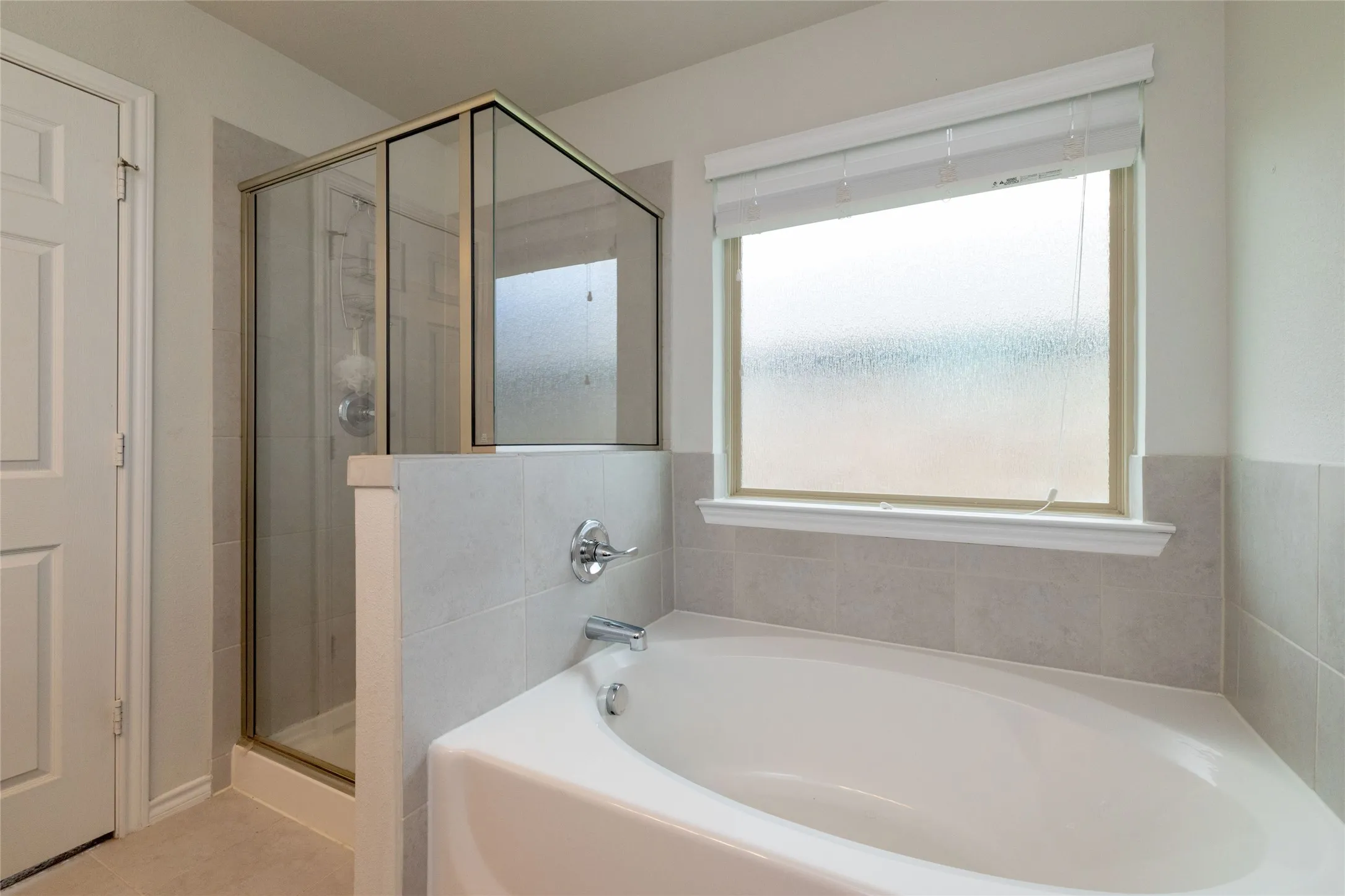 Full bathroom featuring a shower stall and a bath