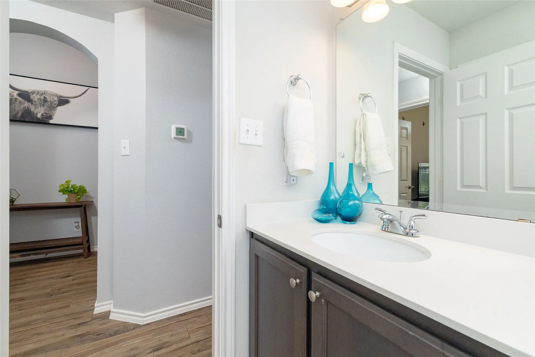 Bathroom featuring vanity and light wood-style floors