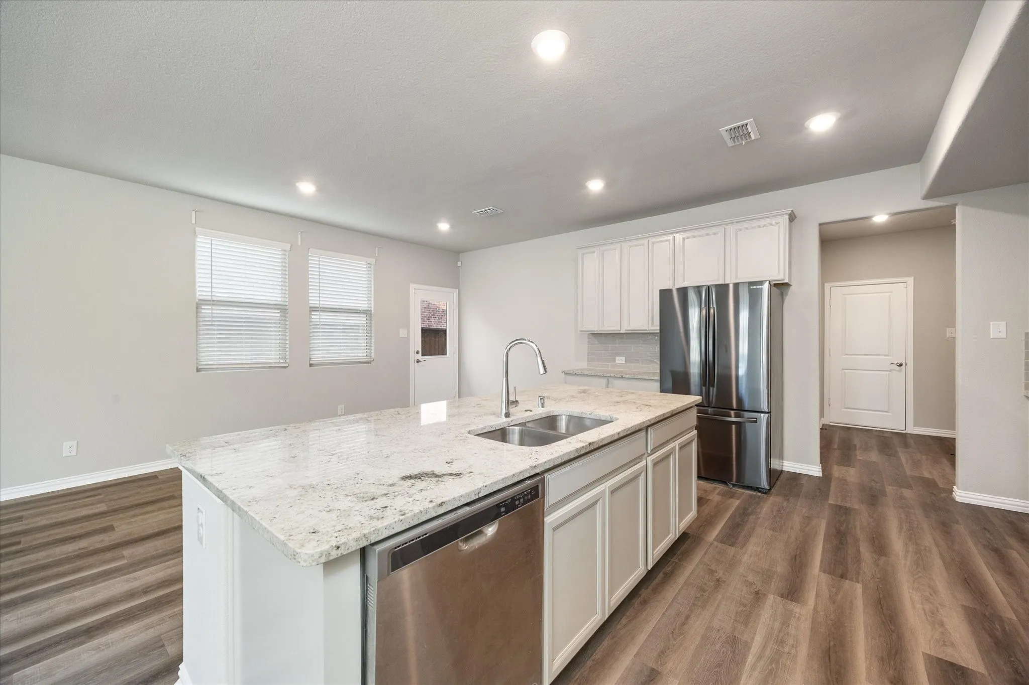Quart countertops and stainless steel appliances.
