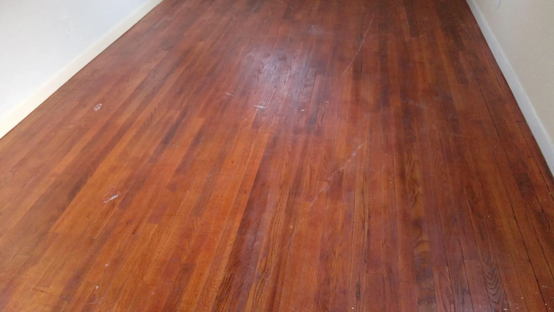 Detailed view of wood finished floors and baseboards