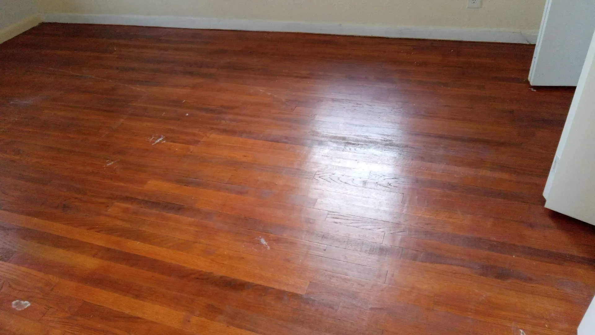 Detailed view of wood finished floors and baseboards