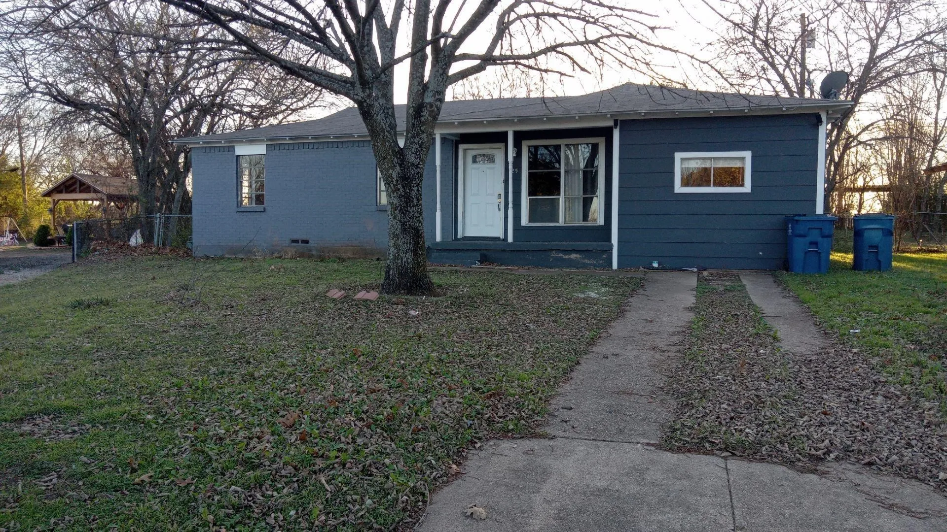 View of front facade featuring a front yard, crawl space, and brick siding