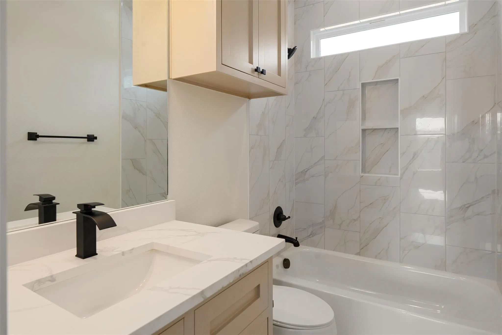 Bathroom featuring vanity and washtub / shower combination