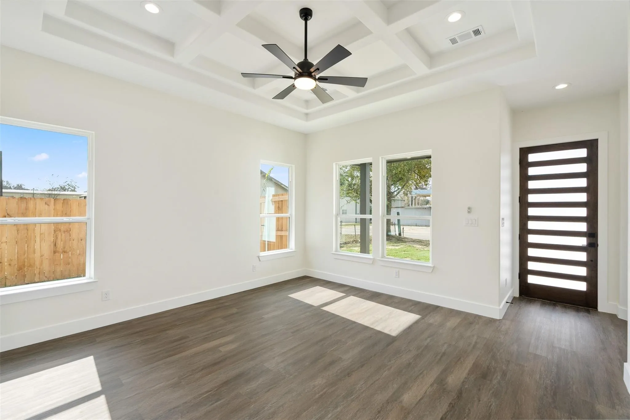 Unfurnished room featuring recessed lighting, coffered ceiling, ceiling fan, and dark wood-type flooring