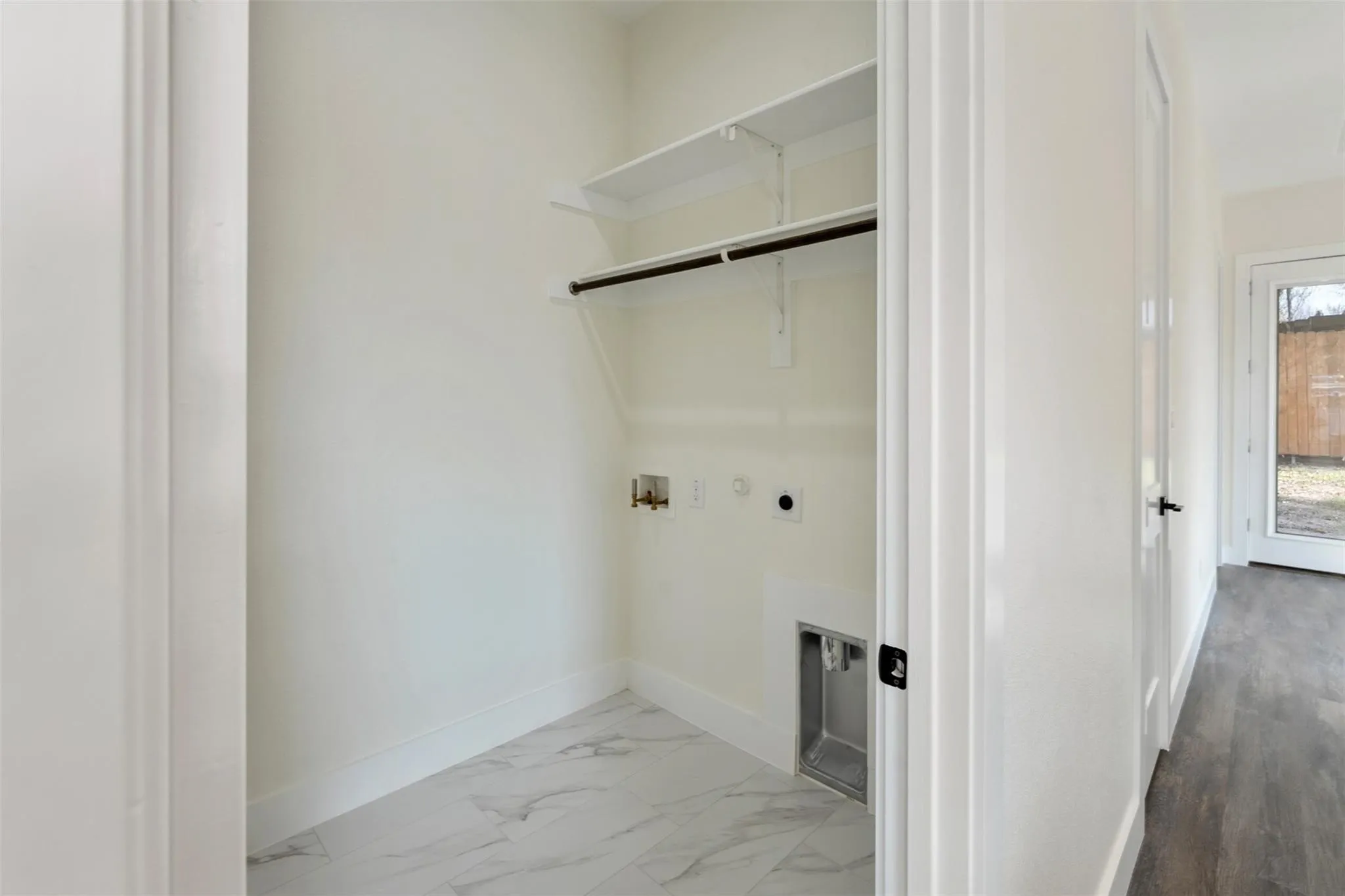 Laundry area with hookup for a washing machine, hookup for a gas dryer, and hookup for an electric dryer