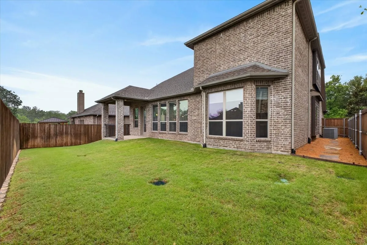This yard is needing your perosnal attention. Beautiful pebble and stone path on both sides of the house.