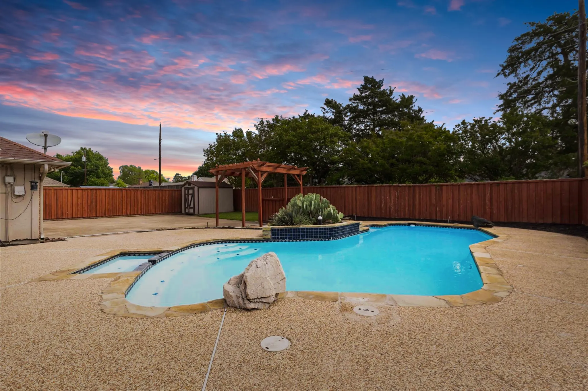 Backyard pool area at 200 Sunny Crest Dr, Murphy TX in the Timbers 3 community with privacy fencing and outdoor entertaining space.