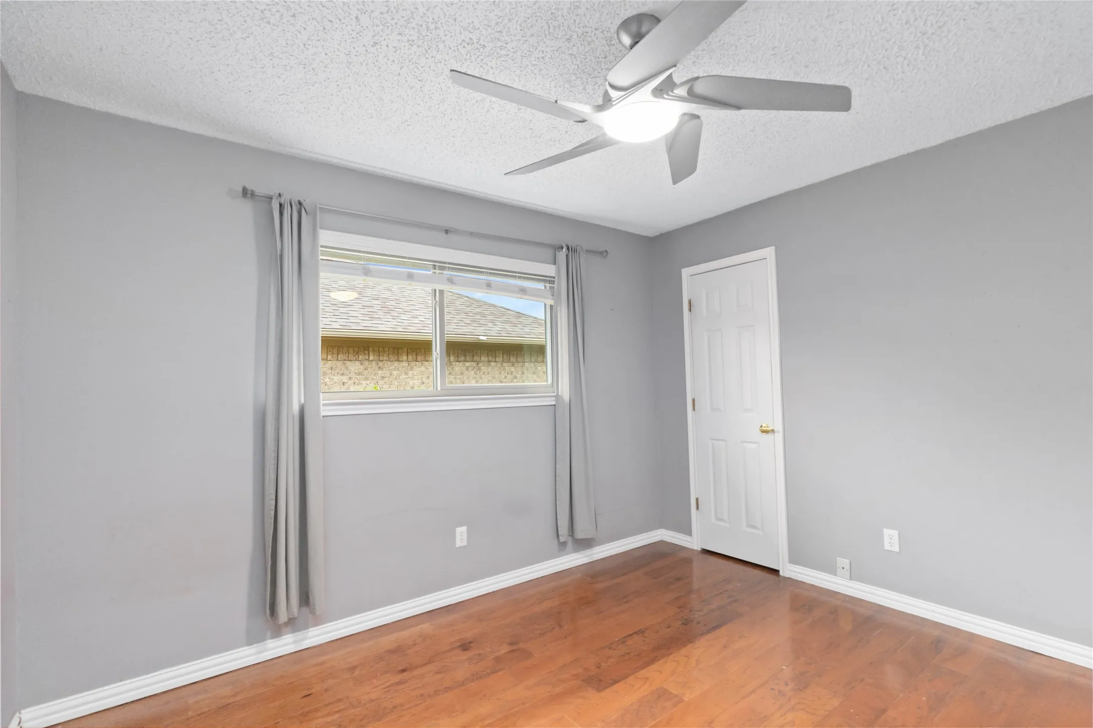 Bedroom at 200 Sunny Crest Dr, Murphy TX in the Timbers 3 community featuring wood flooring and neutral finishes.