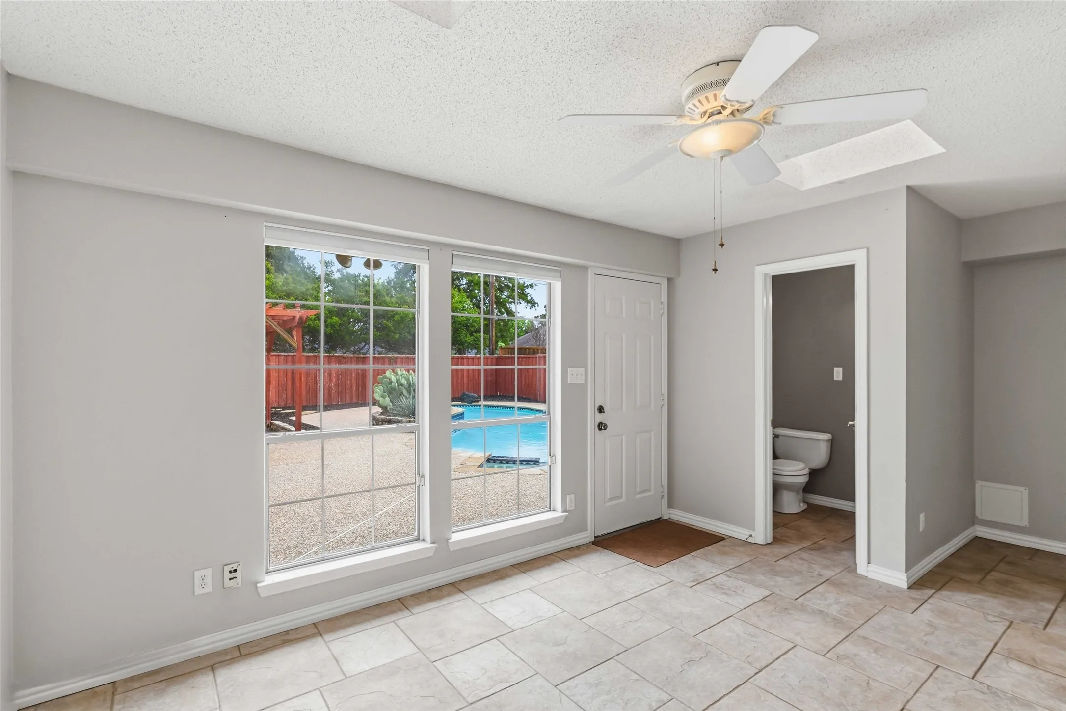 Sunroom-style living area at 200 Sunny Crest Dr, Murphy TX in Timbers 3 with backyard access and natural light.