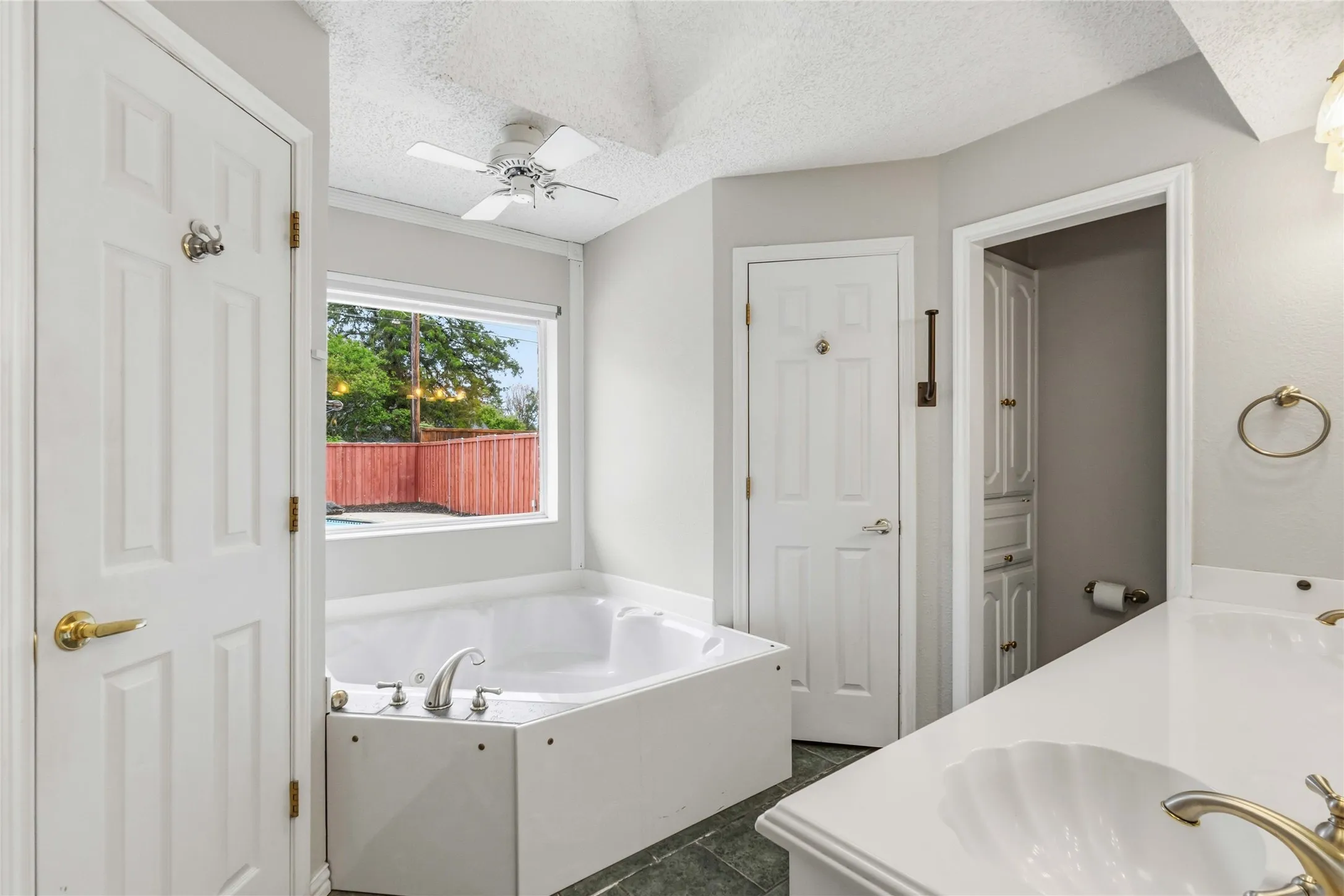 Primary bathroom at 200 Sunny Crest Dr, Murphy TX in the Timbers 3 community featuring soaking tub, dual sinks, and natural light.
