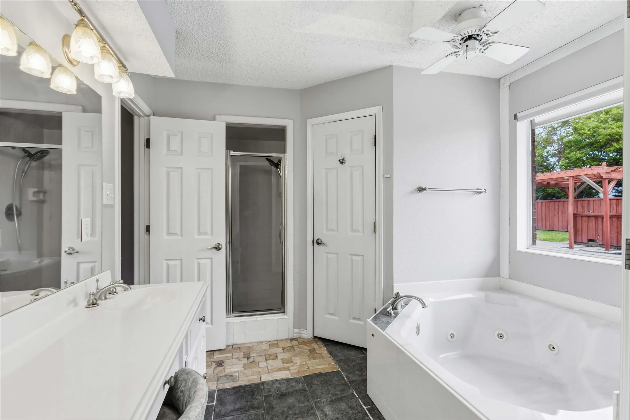Primary bathroom at 200 Sunny Crest Dr, Murphy TX in the Timbers 3 community with soaking tub, separate shower, and spacious layout.