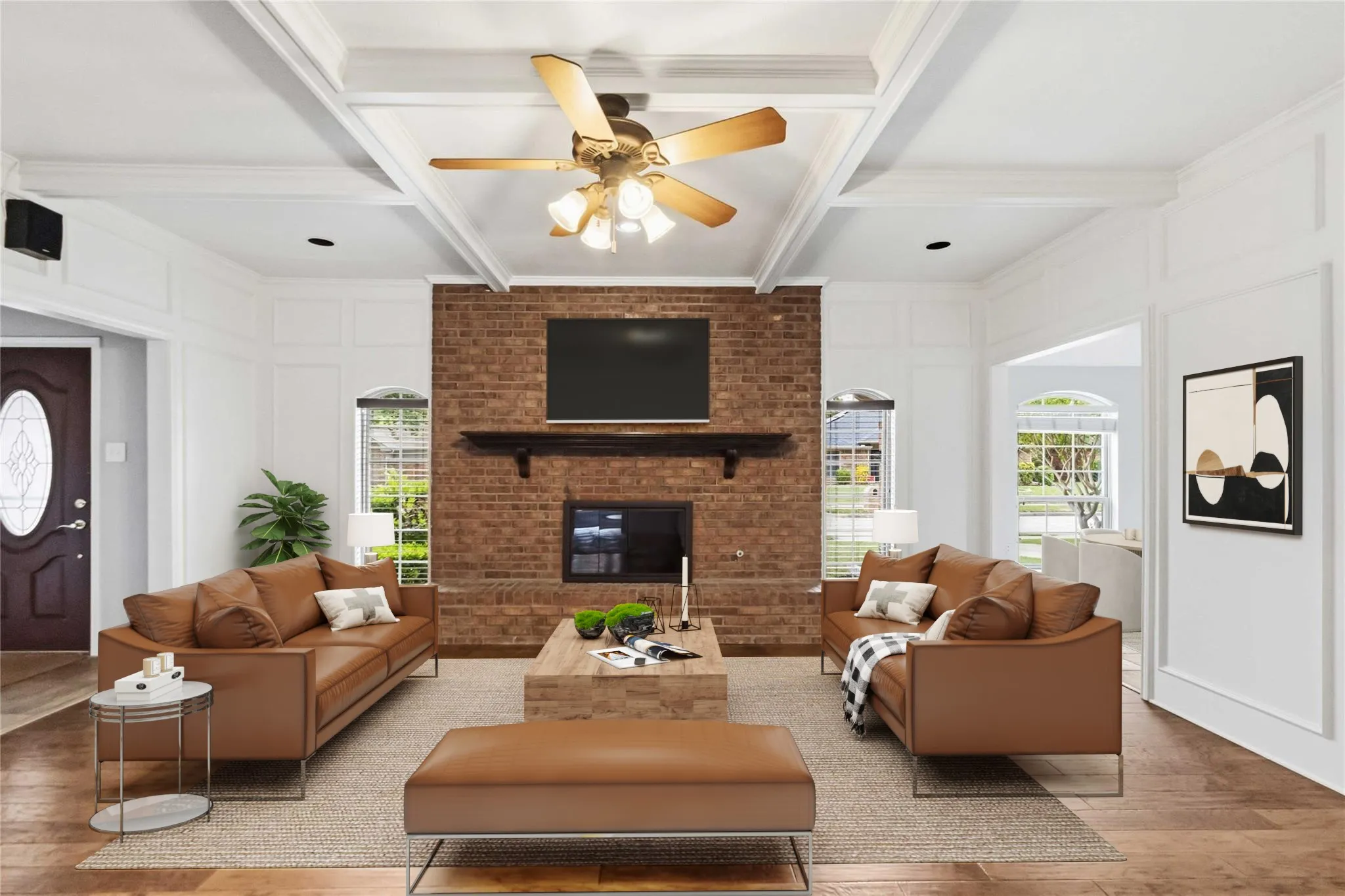 Spacious living room at 200 Sunny Crest Dr, Murphy TX in Timbers 3 featuring hardwood floors, vaulted ceilings, and a brick fireplace with gas logs.