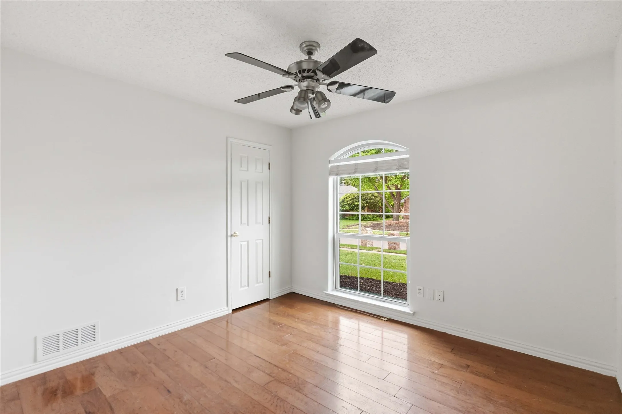 Bedroom at 200 Sunny Crest Dr, Murphy TX in Timbers 3 with hardwood flooring and large window.