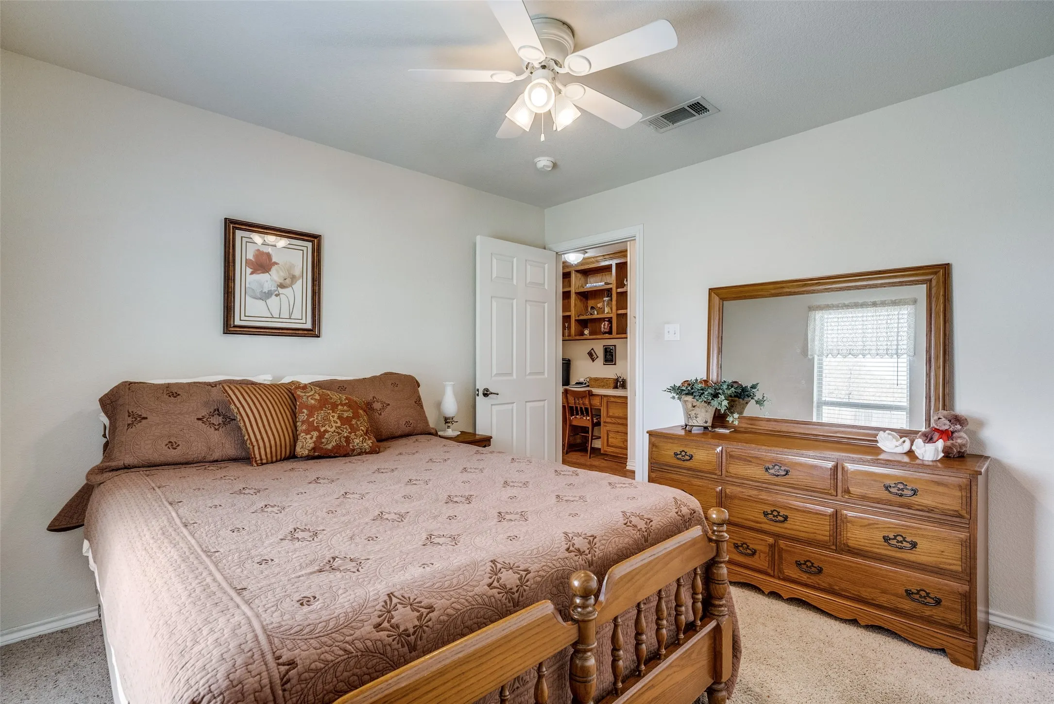 Bedroom featuring light carpet and ceiling fan
