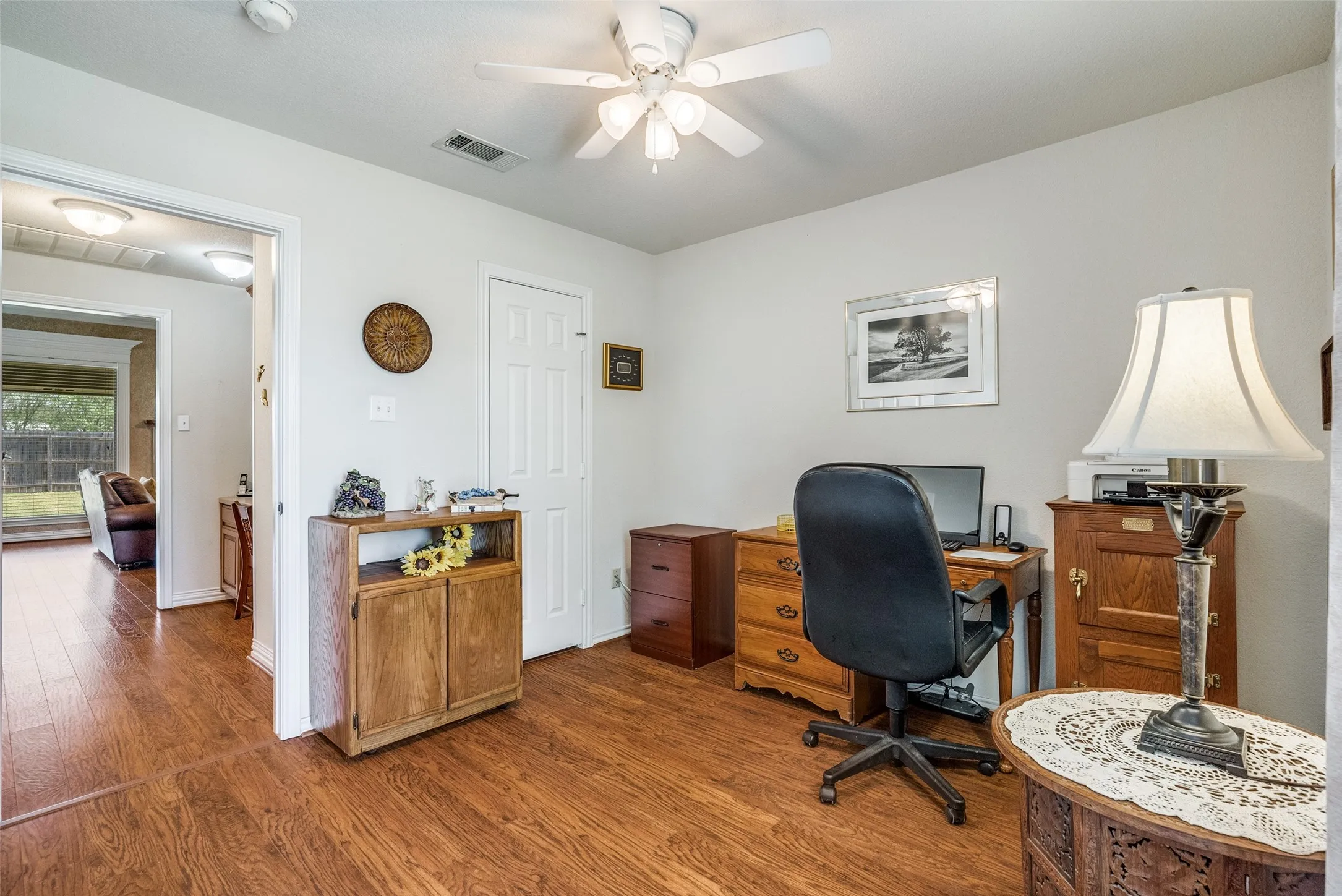 Office space with wood finished floors and ceiling fan